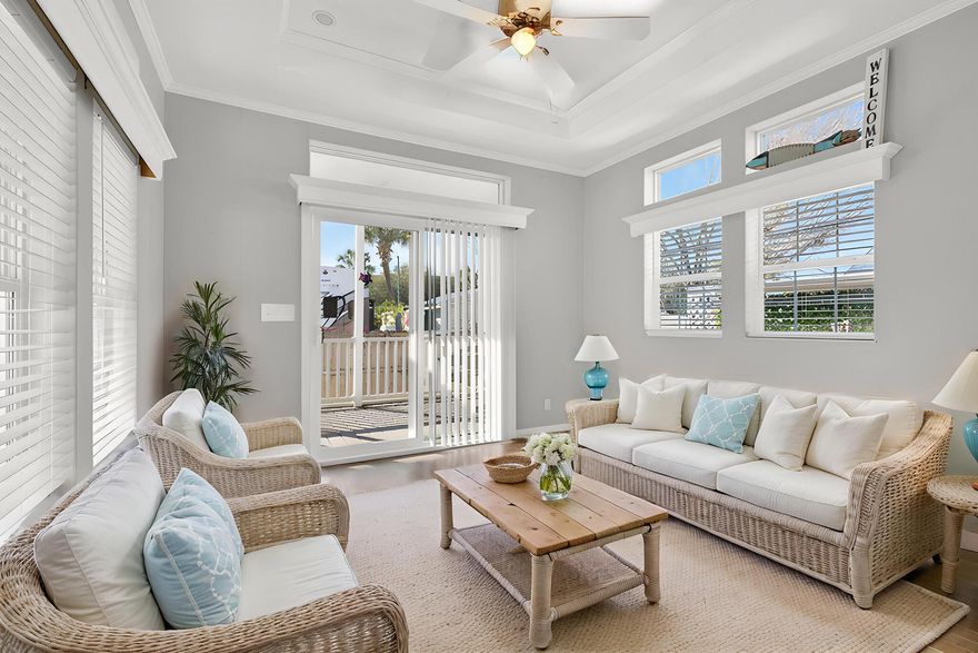 BEACHSIDE LIVING! Just a Short Stroll to the Shore of the sugar-white sandy beach. This custom ''RV Park Model'' built in 2020, features a bright, coastal-inspired design with bay and transom windows that fill the interior with natural light. A metal roof, expansive covered carport, pavers, composite deck NEWLY screened-in deck, all provide wonderful spaces to relax and entertain outdoors. Inside, you'll find beautiful LVP flooring paired with a crisp white/grey palette, coffered and 9-foot ceilings, with smart creative storage throughout. The floor plan is open to the kitchen, breakfast, and living area which flows onto the added 104 SqFt covered screened in deck. The bathroom has been thoughtfully updated with a tub-to-shower remodel, offering a sleek, modern feel and added convenience. The bright, airy bedroom includes built-in closets and dresser for added storage. An EXTRA 112 SQ FT of heated, cooled and insulated multi-purpose outbuilding creates the perfect bonus space, ideal for extra storage, hobby room or peaceful hideaway just steps from the main home. Perfectly sized paved patio includes a hot and cold outdoor shower to rinse off after beach days with an added  extra storage unit included. Situated in a strictly non-rental community for enhanced privacy, and conveniently close to shopping and locals favorite dining. Walk just a couple blocks or take your golf cart to the beach or Pompano Joe's in five minutes or less! Come see this hideaway retreat!