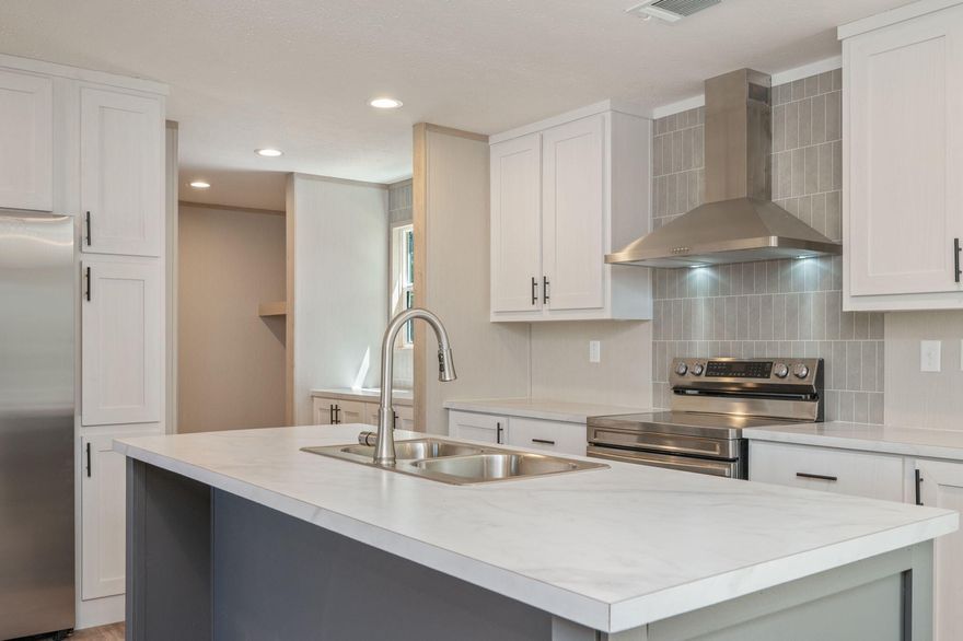 Welcome to this beautiful brand-new 4-bedroom, 2-bath home located on a 1/2 acre lot. Designed with a desirable split floor plan, this home provides added privacy for the primary suite while maintaining a natural flow ideal for everyday living.
The upgraded kitchen is a true highlight, featuring stainless steel appliances, a sleek vent hood, custom color cabinetry, and a dedicated coffee bar that adds both style and convenience. The thoughtful layout makes the kitchen the heart of the home, perfect for gathering with family or hosting guests.
Brick skirting enhances the exterior with durability and curb appeal, while the large back deck creates an inviting outdoor space. With four spacious bedrooms, this home offers flexibility for growing families, guests, or a home office.
