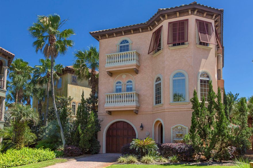 Named the Emerald Palazzo this home and neighborhood are fashioned after the villas on the French Riveria. This exceedingly gracious three-story vacation home exudes elegance and has 4 bedrooms & 2.5 baths. The home overlooks the lavish community lagoon pool with fountains and a bubbling hot tub, plus lush landscaping. An opulent spiraling staircase tower leads to the giant Master Suite with a romantic balcony.  All the guest bedrooms have access to poolside patios or balconies.  Stamped concrete floors, a spacious open living area and a fourth bedroom on the third floor that could be an office make this home perfect for the owner who wants to live in the home or rent. Perfect location just a few min walk to the beach, local restaurants and shopping. This is a must see!