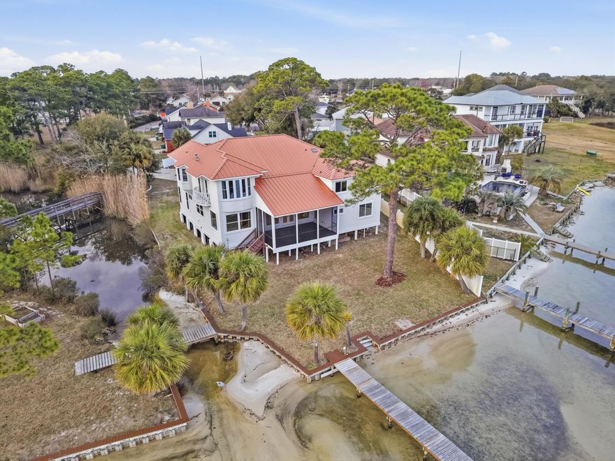 At the edge of the Intracoastal waters of Santa Rosa Sound, this elevated coastal contemporary residence offers exceptional privacy and sweeping waterfront views. Positioned at the end of a private street in Mary Esther, the home is bordered by the sound and framed by stately brick column entry walls.

Inside, five bedrooms, two bonus rooms, three full baths, and one half bath are thoughtfully arranged to maximize natural light and panoramic water views. Nearly every room overlooks the sound, allowing the waterfront to shape daily living. The main level features a gracious foyer and staircase leading into a living room where expansive windows frame the water as an ever-changing backdrop.

The kitchen is designed for entertaining with abundant cabinetry, a chef's pantry with space for a secondary refrigerator, smooth-top cook surface with double ovens, and a prep sink within the island. From the kitchen and dining areas, 180-degree views stretch across the water.

Upstairs, the primary suite offers elevated vistas, a walk-out Juliet balcony for coastal breezes, a private fireplace, and a spacious en suite bath with double vanity, garden tub, separate shower, private water closet, and extensive walk-in closet.

Outside, white-sand shoreline access extends just beyond the backyard. A private dock spans more than 200 feet and includes an 18,000-lb boat lift, 4,000-lb lift, and jet ski lift -- creating effortless access to the calm waters of the sound.

Significant 2022 improvements include a new copper roof, upgraded insulation, refreshed stucco siding, fresh exterior paint, and hurricane-rated windows.

Conveniently located between Fort Walton Beach and Navarre along the Emerald Coast, the property offers easy access to Hurlburt Field, Eglin Air Force Base, and Highway 98 while maintaining the tranquility of a private waterfront setting.