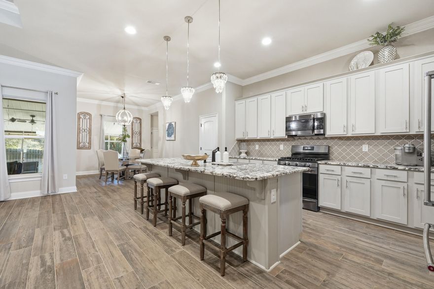 BEAUTIFUL, well-maintained home! This 4BR/3BA residence offers over 3,010 sq ft of thoughtfully designed living space, built in 2019 and ideally located just MINUTES from NAVY FEDERAL and the Shopping, dining, and medical conveniences of 9 Mile Rd. The Exterior showcases a timeless Brick & Stucco finish, seamless gutters, and professional landscaping for standout curb appeal. Inside, you'll find an open-concept layout with a FORMAL dining room and dedicated office, enhanced by COFFERED ceilings, crown molding, tray ceilings, Custom Lighting, FEATURE walls, and recessed lighting--creating a warm yet elevated feel throughout. The kitchen is a true centerpiece, featuring a LARGE granite island with bar seating, stainless steel appliances, tile backsplash, soft-close cabinetry, and a 5-burner gas range. The split floor plan offers privacy with three guest bedrooms and two full baths, including a convenient Jack-and-Jill layout. The SPACIOUS primary suite includes a sitting area, walk-in closet with direct laundry access, and a spa-like bath with double vanities, soaking tub, and tiled WALK-IN Shower. Enjoy year-round relaxation in the screened-in SUNROOM with ceiling fans and full electrical--perfect for entertaining or unwinding. Additional highlights include CUSTOM LIGHTING, heated and cooled oversized 2-car garage with a painted floor.