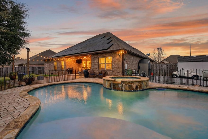 Welcome to Redstone Commons! This 5-bedroom, 3-bath all-brick home offers 2,506 sq. ft. of stylish comfort on a 0.29-acre lot. Manicured landscaping, oversized parking, and a side-facing garage create standout curb appeal. Inside, soaring ceilings with double tray details and elegant molding frame a bright, open living area filled with natural light from wall-to-wall windows. The kitchen features rich wood cabinetry, granite countertops, a large island with breakfast bar, glass tile backsplash, stainless-steel appliances, and a cozy breakfast nook. Enjoy a covered back patio, a beautiful in-ground pool with spa, and plenty of room for entertaining. Paid off Solar Panels.
