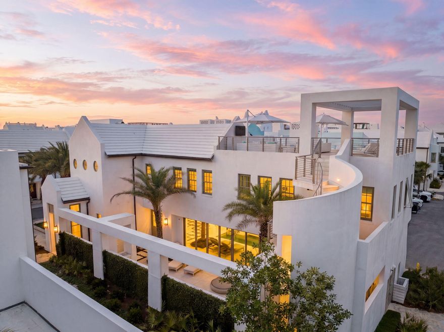 62 S. Charles Street is a striking contemporary residence designed by renowned A Boheme Design, blending modern luxury with the tranquility and natural beauty of Palmera Park. Ideally located south of 30A, this exceptional home embraces park views while remaining just moments from the Gulf green and sugar-white sands.

A private sanctuary concealed behind white stucco walls and sculptural structural columns, the residence was thoughtfully designed to accentuate its bold architectural lines and lush landscaping. Every detail creates a seamless connection between modern artistry, coastal elegance, and serene outdoor living.

Thoughtfully designed for both full-time living and effortless entertaining, the home offers 3,845 square feet of conditioned living space with expansive indoor and outdoor living areas. Featuring four bedrooms, including two luxurious primary suites, two guest suites, laundry rooms on each level, and a media room with wet bar, every detail was curated for comfort and sophistication.

The heart of the home showcases an open-concept kitchen, dining, and living area seamlessly connected to the outdoor courtyard and pool through dramatic 30-foot multi-slide glass doors, creating a true indoor-outdoor living experience. The gourmet kitchen is beautifully appointed with a large island, a 48-inch Miele range, Sub-Zero refrigeration, wine cooler, and icemaker. Imaginative design details continue throughout the home, including a stunning book-matched marble fireplace that beautifully complements the countertops, while custom finishes inside and out add layers of architectural intrigue.

The outdoor spaces are nothing short of spectacular. A 32-foot water wall cascades into the length of the pool, complemented by a gas fire pit and covered summer kitchen featuring a Wolf grill, Sub-Zero refrigerator, and icemaker. The surrounding outdoor living areas and plunge pool cultivate an atmosphere of refined leisure and elevated coastal living.

A sculptural concrete helicoidal staircase leads to the third-floor rooftop terrace where beautiful sunset vistas and iconic views of Alys Beach architecture await. Entertaining and relaxation are elevated by the abundance of thoughtfully designed indoor and outdoor gathering spaces.

Both primary suites overlook the serene beauty of Palmera Park and feature spa-inspired bathrooms with floor-to-ceiling marble, dual vanities, expansive showers, and spacious walk-in closets. The first-floor primary suite also enjoys a private courtyard with a whimsical outdoor soaking tub, offering a tranquil retreat to relax and unwind while embracing the peaceful ambiance of the surroundings.

Interior finishes blend warmth and contemporary elegance, with shell stone flooring flowing throughout the first floor and continuing into the courtyard, while rich walnut flooring defines the second level. Twelve-foot ceilings throughout the first floor enhance the home's open, airy feel, while the dramatic floor-to-ceiling marble fireplace creates a stunning focal point.

Ascending to the second level, a striking zebra wood-clad stair hall with an Italian-made polished stainless-steel railing by Maretti introduces the media room, an additional primary suite, a conveniently located second-floor laundry room, and two spacious guest suites, each featuring beautifully designed baths and oversized closets.

Designed to elevate the coastal lifestyle, this residence offers the opportunity to enjoy the exclusive amenities of Alys Beach, highlighted by access to the private Beach Club--an exceptional retreat reserved for owners.