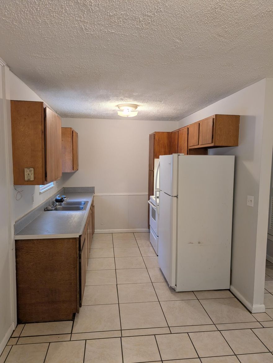 Welcome to this charming 3-bedroom, 1-bathroom home offering 1,324 square feet of comfortable living space in the desirable Skyline Heights neighborhood of Milton, FL. Built in 1959 with sturdy brick construction, this property combines classic appeal with functional features.

Inside, you'll find a versatile bonus room perfect for a home office, playroom, or additional storage. The convenient laundry/utility room adds practicality to everyday living. Step outside to the covered back patio, an ideal spot for relaxing, entertaining, or enjoying the peaceful surroundings.

Currently vacant, this home presents an excellent investment opportunity for buyers looking to add value in a growing area. Whether you're looking for a cozy residence or a rental property, this Skyline Heights gem.... is ready to welcome you.

Don't miss your chance to own a solid brick home with great potential in Milton. Schedule a visit today!