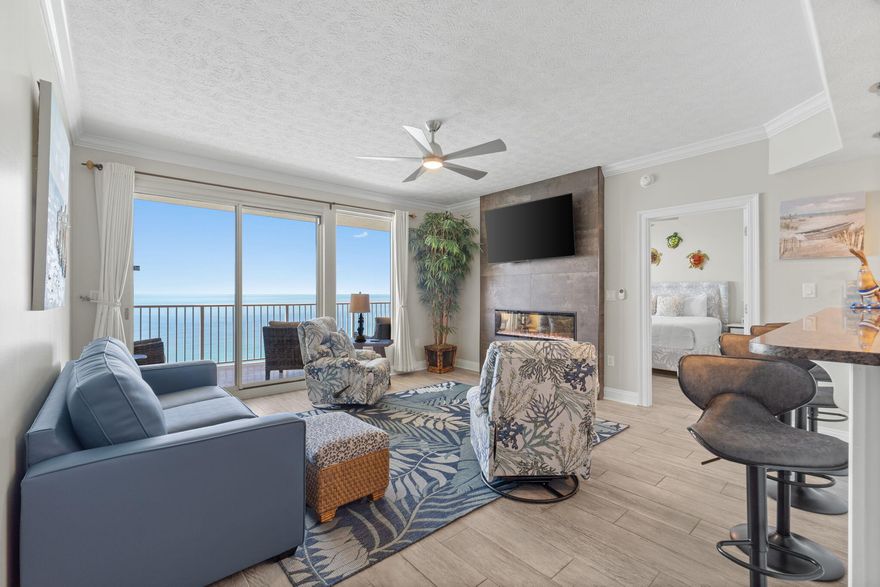 Welcome to Treasure Island Resort, a prominently located gulf-front high-rise condominium in Panama City Beach. This highly desirable, renovated 18th floor unit is comprised of 2 bedrooms plus bunks, 2 bathrooms with 1,370 sq.ft. of an idealistic open floor plan taking full advantage of unobstructed views over the Gulf of Mexico from multiple rooms. A full-blown renovation occurred in 2022 that reflects meticulous attention to detail with notable updates and features throughout in excess of $100,000. This includes updated coastal furniture inside and out, neutral floor-to-ceiling blackout curtains, plantation shutters, neutral paint throughout, wood-look tiles, new light/fan fixtures, new plumbing fixtures, updated kitchen, updated bathrooms, new closet systems and newer components. As you walk into the foyer, you are graced with a beautiful custom marble inlay to set the tone for the rest of the unit. The open-concept kitchen boasts contemporary white cabinetry, granite countertops, stainless-steel appliances with a new stove/oven unit and dishwasher, custom pendant light fixtures, recessed lights and pantry. Within the same space is your dining area with ample sitting, custom light fixture and built-in twin-over-twin bunks with a ladder. Adjoining the space is your large living room offering endless gulf views with the ONLY custom built 52-inch fireplace in the entire complex. Open up the glass sliding doors not only in the living room, but also the primary suite to enjoy the beach air on your almost 30 foot long balcony that gives you plenty of space of casual sitting and dining options.

Just off the main living area is the spacious primary king suite. The updated primary bathroom offers a double vanity with a leather granite finish, LED lighted fog free mirrors, private water closet, a glass enclosed chevron marble inlay shower, custom plumbing fixtures and a custom wood shelving system in the closet. The secondary queen suite also offers an updated bathroom with a single vanity with a leather granite finish, LED lighted fog free mirror, a glass enclosed herringbone patterned tiled shower and a custom wood shelving system in the closet.

This fully-furnished condo makes an ideal primary residence, a second home or an investment property with its unique location on the East end of Panama City Beach offering breathtaking sunsets and expansive views down the coastline, providing an unforgettable backdrop. Resort living offers plenty of amenities for everyone to luxuriate in such as a swimming pool, fitness center, on-site restaurant, beach service and a short distance to St. Andrews State Park, favorite local bars, shopping and restaurants. Come see why life is good at Treasure Island Resort today!