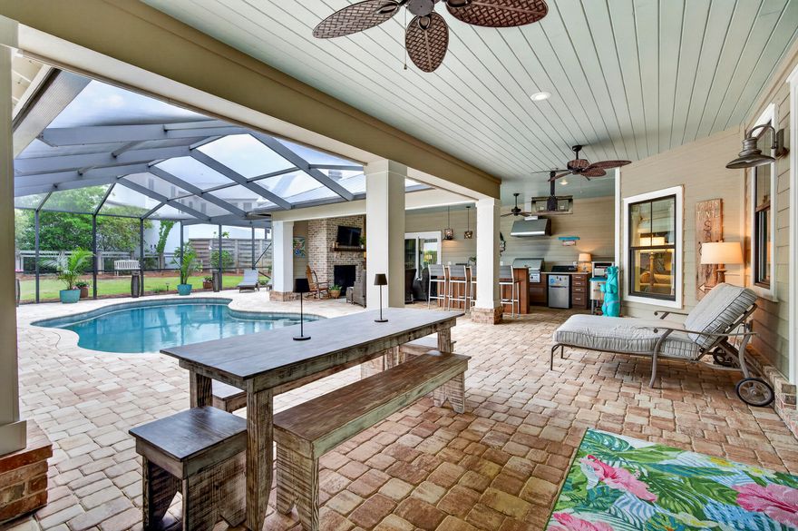 Rarely offered in the highly sought-after Seagrove Village--7th Addition in the heart of Old Seagrove Beach, this exceptional property captures the essence of elevated 30A living. Perfectly positioned on an oversized corner lot at the end of a quiet cul-de-sac, this meticulously maintained residence offers the ultimate blend of privacy, space, and walkability--where golf carts are a welcomed. With no HOA and convenient walking access to two beach easements leading to the Azalea and Gardenia entrances, as well as the 395 access, the location is simply unmatched. Enjoy biking, walking, or cruising to Seaside, Publix, and 30A's most sought-after dining and shopping. Designed to live like a primary residence yet perfectly suited as a second home or short-term rental, this meticulously cared-for property delivers a true resort-style experience. The private, fenced backyard is a special treat featuring large area of space to play. At the center of the home, an incredible outdoor living space creates the ultimate entertaining environment--complete with a resort-style pool and fountain, fully equipped outdoor kitchen and bar with grill, refrigerator, icemaker, pizza oven, sink, and ample storage. A dining area, half bath, enclosed outdoor shower, and a cozy living space with a brick fireplace make this courtyard a year-round retreat, all protected by a screened enclosure with newer screens for added comfort and durability. Seasonal panels allow for enclosed winter entertaining, adding even more versatility.

Inside, the home welcomes you with a private foyer. To one side, two guest bedrooms are connected by a Jack-and-Jill bath, both with direct access to the pool area. On the opposite side of the foyer, an additional bedroom and bath for guests. The exceptional oversized two-car garage opens into a thoughtfully designed mudroom with built-in storage, sink, folding space, and a large stackable washer and dryer--perfect for beach living.

The main living area is open, inviting, and designed for gathering. A spacious dining area easily accommodates eight or more guests and flows seamlessly into the living room, anchored by a stunning double-sided stone fireplace and a stylish wet bar with glass storage, wine rack, and mini fridge. The well-appointed kitchen features a large island with bar seating, abundant workspace, and a cozy keeping room with the fireplace's second side--creating warmth and connection throughout the space.

The rear of the home offers a generous guest suite with private bath, along with the added bonus of a second full laundry room. Just beyond, you'll find an expansive primary suite retreat featuring private sliders that open directly to the outdoor living area. The luxurious primary bath is designed for relaxation, highlighted by a spa-like steam shower that elevates the everyday experience.

Additional highlights include a whole-house Generac generator for peace of mind, extra parking, and a well-maintained paver driveway. Every detail has been thoughtfully curated, making this far from your ordinary beach home. Whether you're seeking a full-time residence, vacation retreat, or investment opportunity, this Seagrove gem captures the essence of elevated coastal living. Last but not least newer screens over the outdoor living and a well for your exterior irrigation.