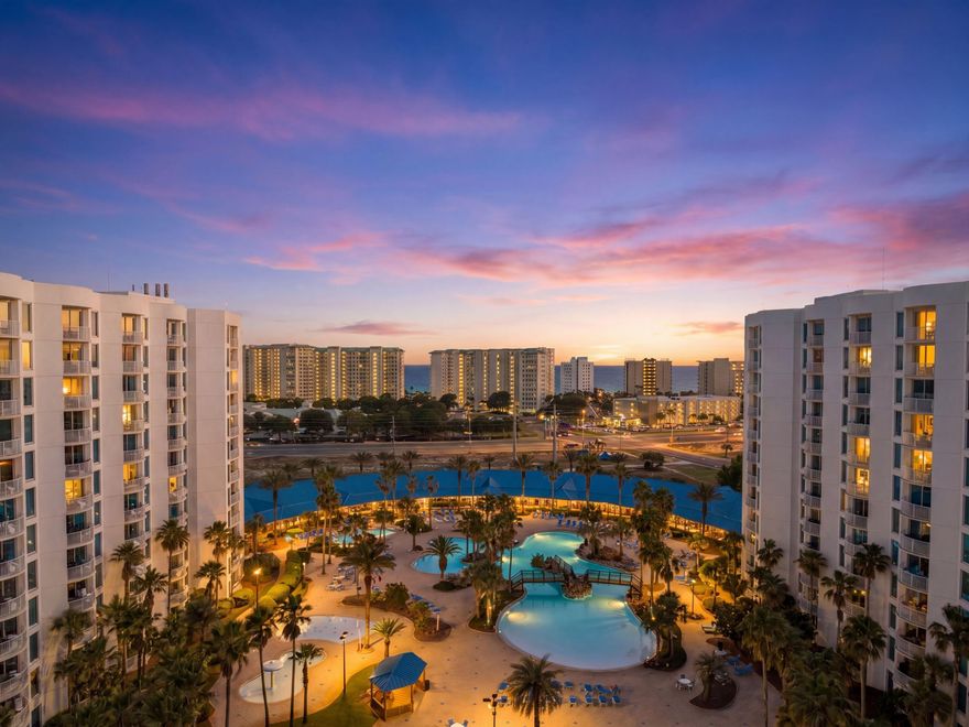 High above the palms and pool deck, this eighth-floor residence captures what may be one of the most commanding vantage points in the resort. From the oversized balcony in the coveted end-stack position, panoramic views stretch across the Gulf of America, Henderson Beach State Park and the Destin skyline, with both eastern sunrises and glowing western sunsets unfolding from the same outdoor living space.

Offered furnished and rental-ready, the three-bedroom, two-bath condominium pairs generous square footage with a thoughtful split-bedroom floor plan that balances privacy and gathering. The spacious main living area flows seamlessly toward the balcony, creating an airy coastal setting ideal for morning coffee, evening cocktails or simply watching the coastline shift colors throughout the day. Recent updates include luxury vinyl tile flooring and carpet, refreshed countertops, tile backsplash, dishwasher and washer and dryer, adding comfort and functionality throughout the residence. Ample closet space and an in-unit laundry room continue the ease of ownership, whether used as a primary residence, second home or investment property.

Beyond the residence itself, The Palms delivers a resort-style experience centered around one of the area's most expansive amenity packages. Owners and guests enjoy an 11,000-square-foot lagoon pool with waterfalls and spa, a children's pool and splash area, playground, lighted tennis courts, pickleball and basketball courts, fitness center and seasonal shuttle service to the beach. Covered parking and an electric vehicle charging station add convenience, while HOA dues include all utilities for simplified ownership.

Positioned just moments from Destin's dining, shopping and sugar-white shoreline, this residence offers the rare combination of panoramic views, flexible livability and full-scale resort amenities in one of the area's most recognizable vacation destinations.