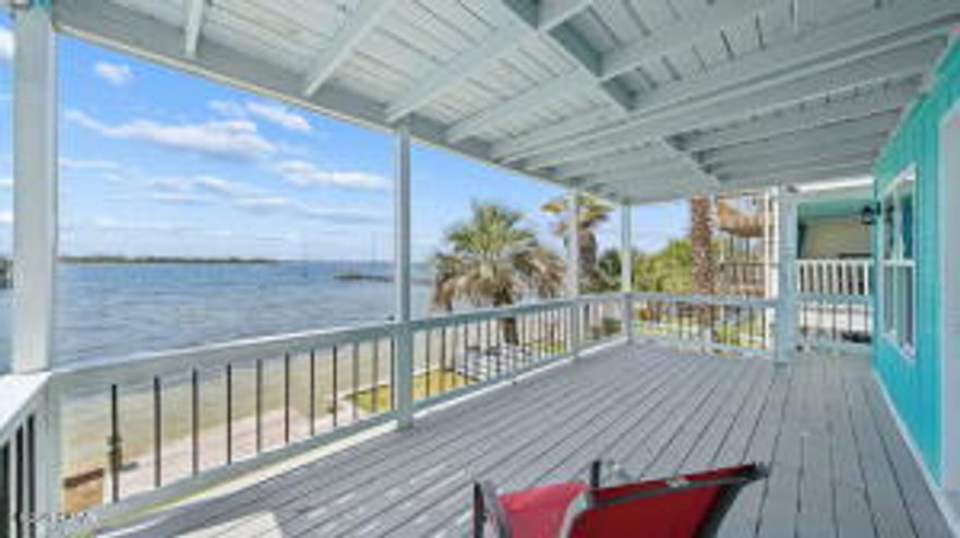 One of the best-priced bayfront properties with direct Gulf access in Bay County, this beautifully updated three-story East Bay townhome delivers deep-water access, stunning views, and exceptional versatility--including a fully independent 1 bed / 1 bath ground-floor apartment. Whether you're seeking a primary residence, second home, VRBO/Airbnb investment, or a live-upstairs/rent-downstairs setup, this property checks every box. NO HOA. 
SHORT TERM RENTAL ARE ALLOWED!
Located just 5.5 miles from Tyndall AFB and minutes from Sacred Heart Hospital, this home offers convenience paired with true Old Florida charm. The exposed beam ceilings create a warm, heritage feel, while numerous modern upgrades make the home move-in ready. Recent improvements include a brand-new seawall, new porch decking, new fencing, new windows on the 3rd floor and master suite, new LVP flooring, new cabinets with quartz countertops, new bathroom tile, a newer metal roof, a 5-year-old HVAC, and a 3-year-old water heater.

Step inside the main level and enjoy a spacious great room and kitchen that open to a 22' x 10' covered waterfront balcony--perfect for hosting, relaxing, and taking in the breathtaking sunsets over East Bay. The middle level features the master suite with its own private 22' x 10' balcony, offering peaceful sunrise and sunset views. This floor also includes a large guest bedroom capable of accommodating two beds, along with a full guest bath.

The ground-floor apartment is a standout feature: a complete 1 bed / 1 bath unit with full kitchen, separate entrance, and its own A/C. It functions as a true lockout unit, ideal for rental income, guests, or multigenerational living. The occupant can enter through the backyard and walk around the side of the home to their vehicle without accessing the main residence.

Every floor of this home offers beautiful bay views. Step outside to your private beach with seawall, just steps from your door. Ownership also includes 1/11 interest in the 90+ ft ''Pitts Row'' dock, where you can park your boat, jet skis, or other watercraft--or build your own private dock if desired. With deep water and easy access to East Bay, Shell Island, and the Gulf of Mexico, this is a boater's dream.

This rare waterfront opportunity blends charm, upgrades, income potential, and unbeatable access to the Gulf. Schedule your showing today and experience the best of East Bay living.