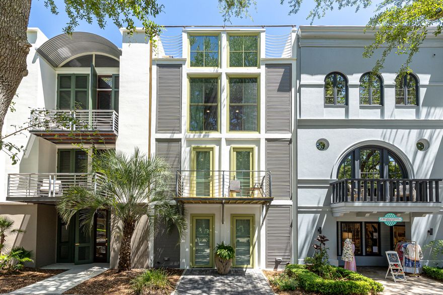 Nestled in the heart of Ruskin Place Artist Colony in Seaside, Florida, this stunning 3 story, 4 bedroom row house designed by acclaimed New York architect, Walter Chatham, was featured in Architectural Digest. Located just north of Town Center this residence offers urban sophistication with a live/work lifestyle, as well as unlimited rental opportunities.
Uncorked! faces the iconic Ruskin Park, beautifully landscaped and reminiscent of New Orleans Jackson Square.  The house features an elevator, sun drenched floor to ceiling windows, a private balcony on the second level overlooking the park, a roof top deck with a gulf view for lounging, sunbathing or star gazing. This home offers unparalleled living in one of Florida's premiere destinations.
Ground Level:  Two bedrooms, full bath, laundry room and adaptable space for a commercial, studio or residential use.
Second Level:  Two bedrooms, full bath, balcony.
Third Level:  Open concept living/dining, gourmet kitchen and powder room.
Fourth Level:  Outdoor living, roof-top deck. Stunning views of Seaside and the Gulf.
Bonus/Potential:  Substantial room for expansion off the second level to create an additional 200 square feet of interior space with a carport below and a deck above. 
Live, work, and create in coastal luxury. More than a home, this is a masterpiece of New Urbanism design.