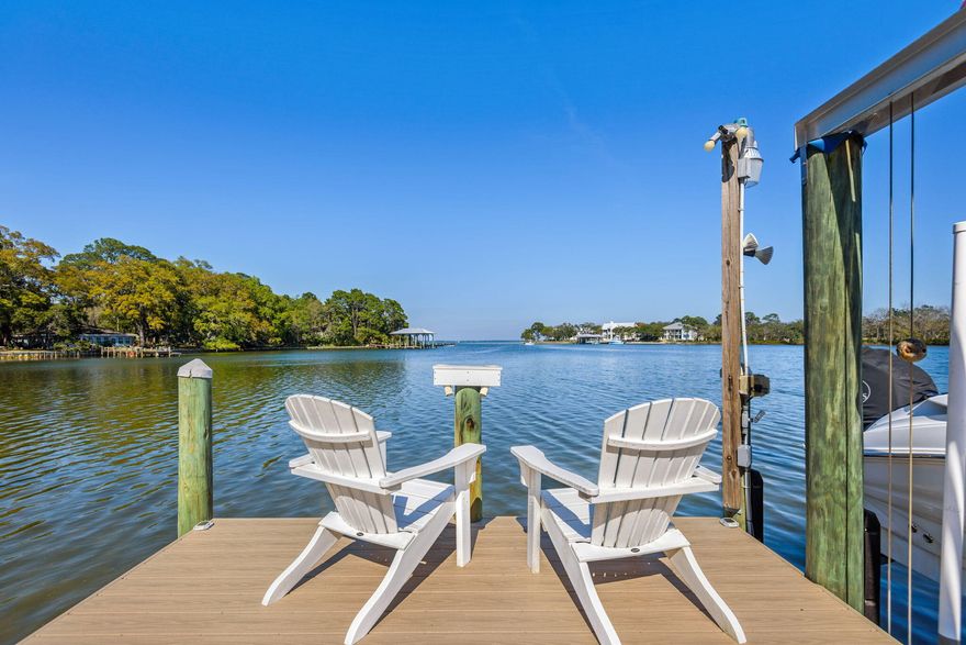 Welcome to Sacred Oaks, a waterfront community on Mack Bayou.  An exceptional private retreat nestled in the heart of Santa Rosa Beach, this beautifully appointed residence offers the perfect blend of refined elegance and Southern Charm.  The brick paved streets and driveway with French gas lanterns at the entry are shaded with moss-draped oaks and views of the deep water bayou that opens up to the Choctawhatchee Bay, two boat docks with lifts, two jet ski lifts and a new salt water swimming pool captures the dream of Florida coastal living.  Inside you'll find an elevator, engineered wood floors throughout and updated features including expanded upper level windows to take in the panaramic waterview.  The kitchen is appointed with granite countertops and modern appliances and is fully equipped with natural gas (stove, pool heater, fireplace and tankless water heater), Culligan water treatment system, and modern smart-home convenience.  A brand-new seawall, full-property irrigation system and a newly fenced pool area with it's own lot totaling rare bayou frontage of 90'.  Additional bedrooms are generously sized offering flexibility for guests, a home office, or a growing family. Step outside to enjoy expansive porches and outdoor areas perfect for morning coffee or simply soaking in the coastal breeze. Conveniently located to Sandestin Beach Resort and Grand Blvd. with dining and shopping, access to world-class golf courses, scenic bike paths on 30A and the beautiful white sandy beaches of South Walton are a few minutes away.