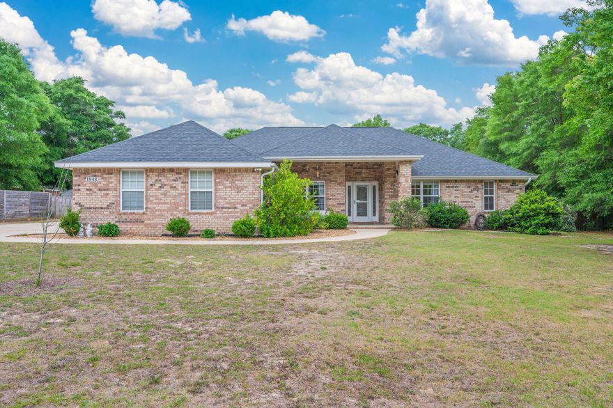 What!!!? 4BR Brick Home, 1 Acre in Baker
Contemporary 4 bed, 2 bath all-brick home with a split floor plan and tons of space inside & out! Bright, open kitchen with epoxy countertops and eat-in area. Flexible bonus room = dining, office, or playroom. Primary suite features tray ceiling, separate shower & whirlpool tub.
Enjoy a covered back porch, fenced yard, and TWO storage buildings (one with power!). Side-entry garage, solar panels for energy efficiency, and a 2021 roof = big perks, Don't miss this one!