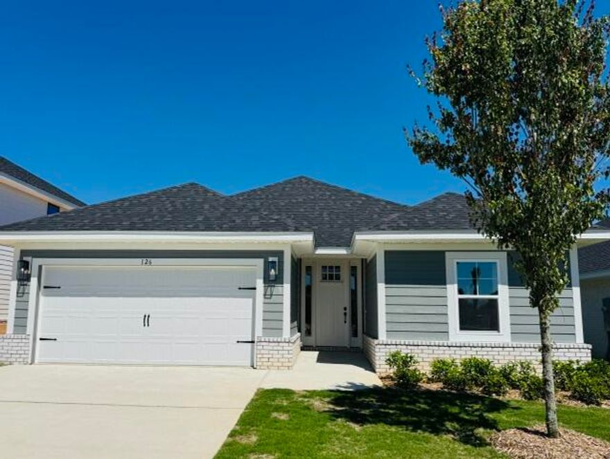 Located just a 20-minute drive to the white-sand beaches of South Walton, this Craftsman-style home blends coastal convenience with modern comfort. Offering 3 bedrooms and 2 baths, the home features Hardiboard siding with a brick skirt, 9' ceilings throughout, and elegant 10' tray ceilings in the owner's suite. Quartz countertops highlight the kitchen and baths, complemented by sleek black faucets and hardware. Durable CoreTec Pro Plus luxury vinyl plank flooring flows throughout, while the oversized owner's suite with a large walk-in closet provides a relaxing retreat. Photos are of a similar home.   Ask about our 4.99% Fixed Rate available for this home.