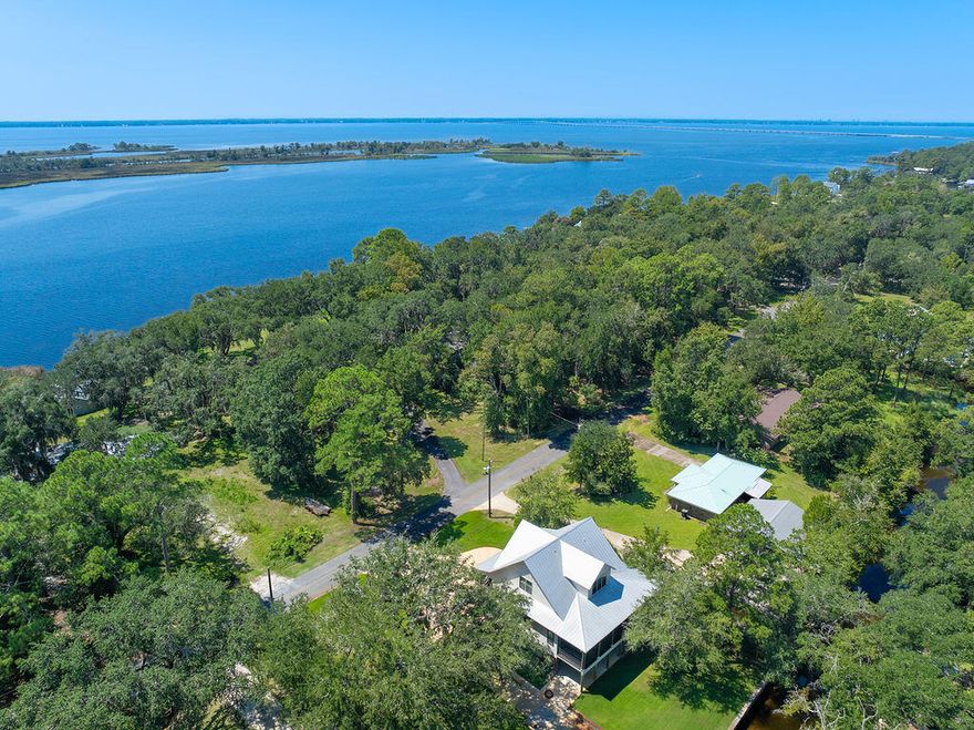 Discover timeless coastal elegance in this exceptional canal-front luxury home where classic Southern architecture meets the tranquility of 'Old Florida' charm. With 130 feet of protected canal frontage and a boat lift, it is an easy boat ride to Choctawhatchee Bay.  You can relax on the front porch deck while taking in the view of the bay, or settle in on the back screened porch, overlooking the lush yard and canal. This home boasts three stories with an elevator for your convenience. The well-appointed kitchen meets the needs of any chef, with a butler's pantry and plenty of counter space! The open floor plan allows for easy entertaining across the main living areas. This property delivers a rare blend of privacy, elegance, and waterfront lifestyle, an ideal sanctuary for you.