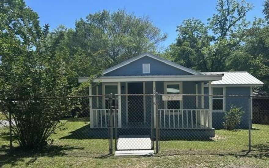 This charming , fully remodeled 2 bed, 1 bath home in the heart of DeFuniak Springs  spans nearly 1,100 sq. ft. It features a covered porches perfect for sipping morning coffee or sweet tea. Highlights include tongue and groove ceilings, wood-look LVP flooring, laundry room, metal roof, and a fully fenced yard. The kitchen boasts stylish backsplashes, eat-in breakfast bar, and stainless appliances, including smooth-top range/oven, built-in microwave, refrigerator/freezer, and full-size dishwasher. Additionally, a versatile flex room can serve as an office, playroom, or dining room. An XL shed offers tons of storage. Best of all, the home is within walking distance to the Lake, downtown DeFuniak, and Walton Middle School, and is less than a 5 min drive to Walmart, I-10 and shopping/dining.