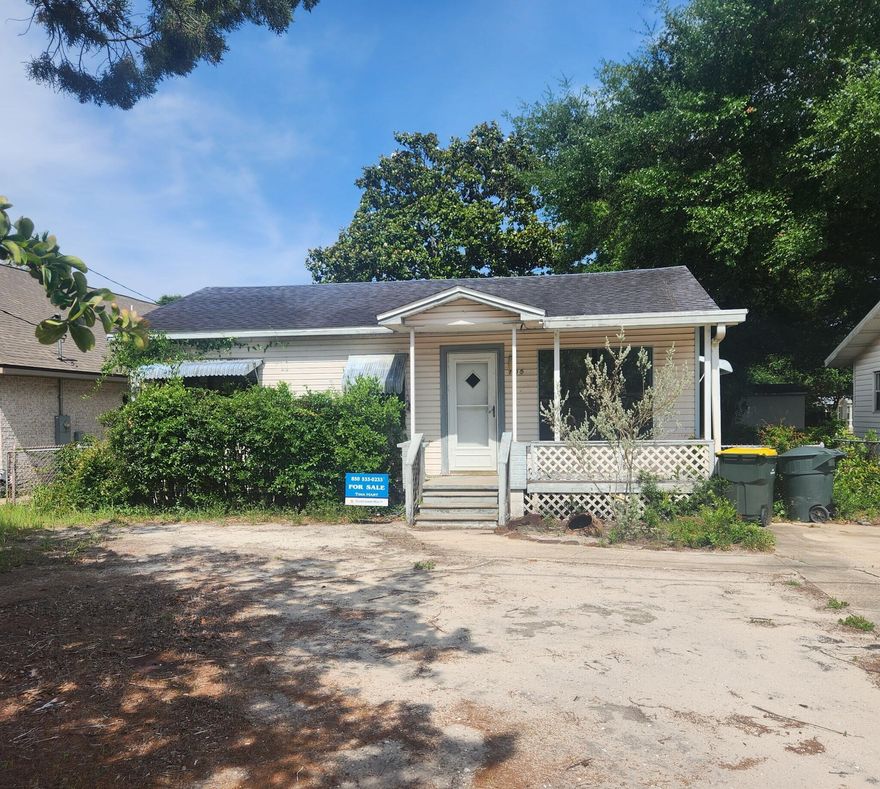 Needs TOTAL renovation.  Sold 'as is' Appliances and inside debris has been removed.  Yard has been partially cleared. The lot is narrow but very long.  Rear access from back of lot. Location is super close to the beach and downtown. 
Build new or rebuild.  Lots of potential for this location!