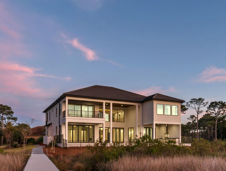 Introducing a rare opportunity to lease a $6M coastal-modern waterfront estate inside gated Kelly Plantation—one of Destin's most coveted luxury communities. This 1.12-acre homesite with approx. 520 feet of deep-water frontage on Jones Bayou, delivers sunset-rich views, a resort-style saltwater pool and spa, and a private dock with quick access to the bay, Destin Harbor, Crab Island, and the Gulf. This newly constructed home was thoughtfully designed for both everyday living and effortless entertaining. The home offers 8,917 total SF (approx. 6,651 SF heated/cooled), 6 bedrooms, 6.5 baths, multiple living spaces, and a 3-car garage with EV charging.

Step through the custom pivot door into the furnished  great room anchored by a gas fireplace wrapped in artisan Venetian plaster. A 26' lighted tray ceiling, custom LED chandeliers, and expansive glass capture water and sky from morning to night. The chef's kitchen features a Wolf gas range, Sub-Zero refrigeration, a quartzite waterfall island, and a fully outfitted butler's pantry with sink, microwave, beverage refrigerator, and ice maker. Adjacent, a glass-front wine room with custom shelving showcases your collection, while the dining area opens directly to the outdoor kitchen for seamless indoor-outdoor gatherings.

The main-level primary suite is a private retreat with its own fireplace and pocketing glass doors to the lanai and pool deck. The spa bath pairs floating, under-lit double vanities and a makeup station with a freestanding soaking tub and an oversized shower featuring dual heads, rain heads, and wands. Dual boutique-style walk-in closets complete the suite. Also on the first floor: a private office with discreet access to a "hidden" safe room, a powder room, a mud room, and a full laundry.

Outdoors, a heated saltwater pool and spa with LED lighting anchor an expansive paver deck designed for sunset lounging. Ceiling speakers set the mood, and the full summer kitchen with natural-gas grill, beverage refrigerator, and ice maker. 

Upstairs, four generous guest suites one secondary primary each feature raised ceilings and designer ensuite baths (floating under-lit vanities; custom tile walk-in showers; one with shower/tub). A fifth bedroom/flex room functions beautifully as a gym, with its own bath and a designated sauna space. Two suites enjoy private balconies (front and waterfront). Lifestyle amenities continue with a deluxe theater/media room offering elevated platform seating, a wet bar with beverage fridge, a large family/bonus living room, a second laundry, and a mechanical/storage room.

Boaters will appreciate the private 120' x 32' deep-water dock with swim platform and Tru-Flow composite decking and personal watercraft. From here, you're minutes to some of the Emerald Coast's finest fishing and frequent dolphin sightings.

Practical luxury underpins the design: four HVAC systems (two per floor), two gas tankless water heaters, gas-heated pool, Wi-Fi/electronic pool-spa-lighting controls, custom LED landscape lighting, irrigation system, gutters, and gas lanterns. The three-car garage (approx. 968 SF) features glass-panel doors, custom cabinetry with sink, and a smart-car charging outlet.

Kelly Plantation living includes an 18-hole championship golf course, owner's club, fitness and yoga facilities, tennis, pickleball, basketball, dog park, nature trails moments from Destin's iconic white-sand beaches, dining, shopping, and galleries. Flood Zone X with FEMA LOMR approval (FFE approx. 8'7") adds peace of mind.

Available as a luxury long-term rental.