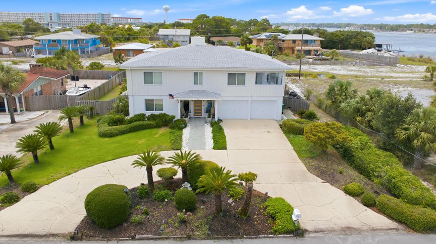 Water views. Steps to the Sound. Moments to the Beach. A thoughtfully designed mid-century, coastal home on highly sought-after Okaloosa Island. Located just steps from direct Intracoastal Sound water access and a short 3-minute walk to Public Beach Access 6, 721 Sailfish Drive offers an exceptional Florida coastal lifestyle centered on water, light, and livability. This expansive 5-bedroom, 3-bath home features Sound views, a remodeled atrium space, and enclosed sunrooms with oversized front-facing windows that bring in abundant natural light, including a cardio/fitness room and a coffee bar with water views.

The open floor plan is designed for both everyday living and entertaining, highlighted by two elegant double-flue fireplaces with white marble rock surrounds that add warmth and architectural balance. A redesigned floating staircase with custom iron detailing creates a strong first impression, complemented by Vermont slate tile, newly installed LVP flooring (2025), cypress wood walls, new lighting and ceiling fans, and custom window treatments.

The updated kitchen includes brand-new stainless-steel appliances (2024), a double pantry, breakfast bar, eat-in dining area, vast water views and seamless flow into the main living spaces. The primary suite is a true retreat, offering Sound water views, private access to a covered deck, a cedar-lined walk-in closet, and a fully renovated ensuite bathroom with a custom tile walk-in rain shower, frameless glass door, LED backlit mirror, and upgraded fixtures.

Two distinct levels of living space provide flexibility for entertaining, hosting, or multigenerational living, with a lower-level living area and wet bar with kitchenette components that work well for guests or in-laws. Outdoors, the home offers a fenced-in oversized pool, covered patio, expansive back deck with screening potential, outdoor shower, and newly installed St. Augustine sod (2025). Elevated at 12'6" above sea level, the home offers peace of mind while delivering a lifestyle tailored for beach lovers, entertainers, and families seeking water views and effortless Gulf access.