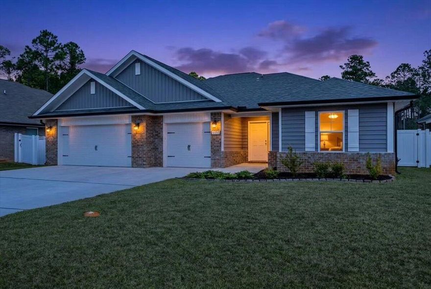 Welcome to a rare opportunity in the coveted community of Creet's Landing, a one-builder neighborhood that has just officially sold out. Now is your chance to own in this highly sought-after East Navarre location!

This beautifully maintained Craftsman-style home, only a year and a half old, offers the perfect blend of modern design, quality construction, and thoughtful upgrades. Featuring 4 bedrooms, 3 full bathrooms, and a spacious 3-car garage, this home welcomes you with a charming covered entry and an inviting open-concept layout.

Luxury vinyl plank flooring flows through the main living areas, complemented by tile in the primary bath and plush carpet in the bedrooms. The spacious primary suite is a true retreat, showcasing the builder's signature zero-entry, all-tile walk-in shower a separate soaking tub, double vanities, and an oversized walk-in closet. A tray ceiling adds an elegant touch to the space.

The heart of the home is the stunning kitchen, complete with:

Granite countertops

A large center island

New pendant lighting over the island

White shaker-style cabinetry

Stainless steel appliances

An expansive walk-in pantry

The light-filled breakfast café overlooks the backyard, creating the perfect spot to start your day. Step outside to the covered rear lanai- ideal for relaxing, entertaining, and enjoying Florida living year-round.

Built with durable 2x6 exterior construction, this home also includes a transferable Maverick structural warranty for added peace of mind. The additional upgrades include;

Recessed kitchen lighting

Floor plug in the main living area

Tray ceiling in the primary bedroom

Built-in blinds in the back door to the lanai

Video camera doorbell and security system 

Lawn pump, well, and full irrigation system

Fenced-in backyard 

Gutter system

Residents of Creet's Landing will enjoy a private recreational area and dog park, adding even more appeal to this already desirable neighborhood. Conveniently located just off Whispering Pines Boulevard in East Navarre, you'll be minutes from shopping, dining, medical facilities, and area military bases.

Opportunities like this don't come along often, especially in a sold-out community. Schedule your private showing today!