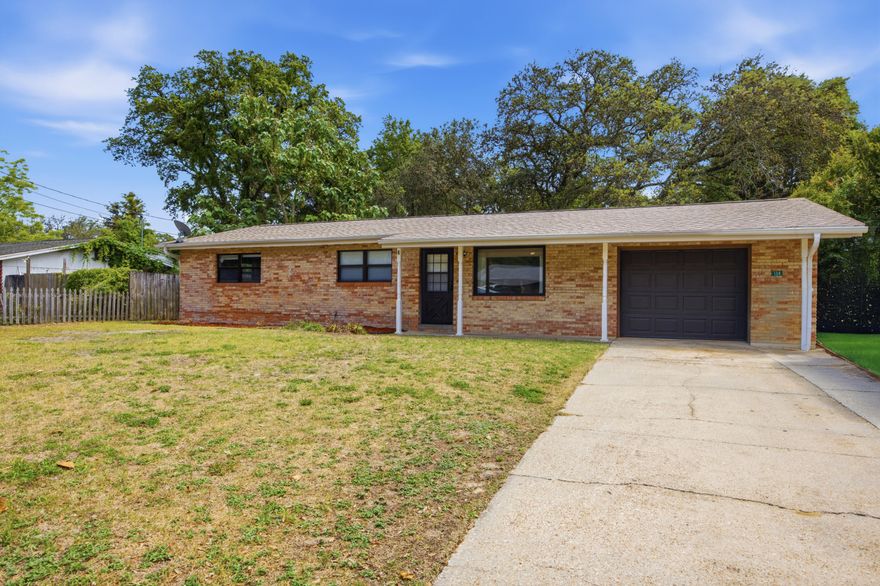 Located between Hurlburt Field and Eglin Air Force Base, 134 NW Virginia Drive puts daily commuting and city access at the center of convenience. Less than a mile from Beal Parkway and Mary Esther Cut Off, you have direct access to Publix, Walmart, Sam's Club, Home Depot, Lowe's, Aldi, restaurants, and everyday shopping without fighting long traffic patterns across town. Public parks, schools, and daily essentials are all nearby. The property is also approximately 10 minutes from the beaches of Okaloosa Island and about 15 minutes from Destin-Fort Walton Beach Airport, making travel, beach days, and weekend plans easy to navigate.

Inside, the layout offers 3 bedrooms and 2 bathrooms with additional functional living space that gives flexibility for a designated dining room, second sitting area, office setup, or extended entertaining space. There is also room adjacent to the kitchen for a breakfast table or casual dining area.

Recent updates include a newly tiled kitchen, newly renovated bathrooms, new carpet, new ceiling fans, and a new hot water heater, giving the home a clean and move-in ready feel from day one.

The Florida room has been recently rescreened, and the covered back patio off the laundry room creates a practical setup for grilling, outdoor seating, or an outdoor spa area.

One of the standout features is the oversized fully fenced backyard with mature trees and a fruit tree already in place, creating both privacy and usable outdoor space.

Move-in ready and priced to sell, this home offers updated condition, functional space, and one of the most convenient locations in Fort Walton Beach for daily living and commuting.