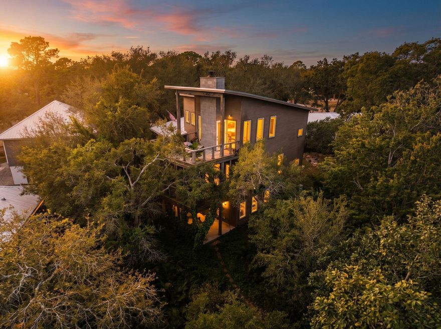 Welcome to ''Contentment,'' an architectural statement home on the shores of Lake Powell at 826 N Walton Lakeshore Drive. Custom-designed over several years by architect Frank Greene, former Town Architect for Rosemary Beach, and completed in 2018, this three-story residence was conceived to maximize light, air, and space while blending coastal lake living with a refined industrial aesthetic. The home takes its name from the entry sculpture created by a local Inlet Beach artist.

Inside, an open-concept floor plan unfolds beneath soaring ceilings accented by exposed wood and metal trim and painted floors with a well-worn patina that evokes urban-warehouse warmth. A custom three-story open stairway - handcrafted from the same structural beams that support the house - serves as a sculptural centerpiece, and four oversized pendants retrofitted from industrial highway mast lights anchor the main living space. A wood-burning fireplace with natural gas starter adds ambiance on cooler evenings.

The chef's kitchen is purpose-built for cooking: custom cabinetry with furniture-style bases, natural quartzite countertops, a raised island for ergonomic prep, dedicated knife and spice drawers, and a separate pantry/laundry room. Appliances include a new refrigerator/freezer, gas cooktop with downdraft vent, built-in oven, microwave, and a lower-level refrigerator/freezer.

The entire upper level is devoted to a private primary suite, opening to its own deck overlooking the lake. Each bath features an art-tile installation that nods to celebrated graphic and wildlife artist Charley Harper, paired with signature glass-block showers. A lower-level safe room/storage area, plus generous attic and crawl space, provide exceptional storage throughout.

Outdoor living flows across three levels: a ground-level patio leading down a path to the private dock, a main-level screened porch, and the primary-suite deck above. The newly resurfaced dock offers social space and an outdoor hot/cold shower, a 5,000-lb. boat lift with a custom heavy-duty aluminum-framed canvas canopy, and a Seahorse-brand elevated double-kayak lift.

Additional appointments include impact-rated windows and doors throughout, a natural gas whole-house generator, a large Browning safe, and low-maintenance landscaping with native plants, ground cover, and natural rock. The covered front porch is accented by custom Rookwood tile wall art.

A rare opportunity to own a true custom, architect-designed lakefront home with direct water access on Lake Powell.
