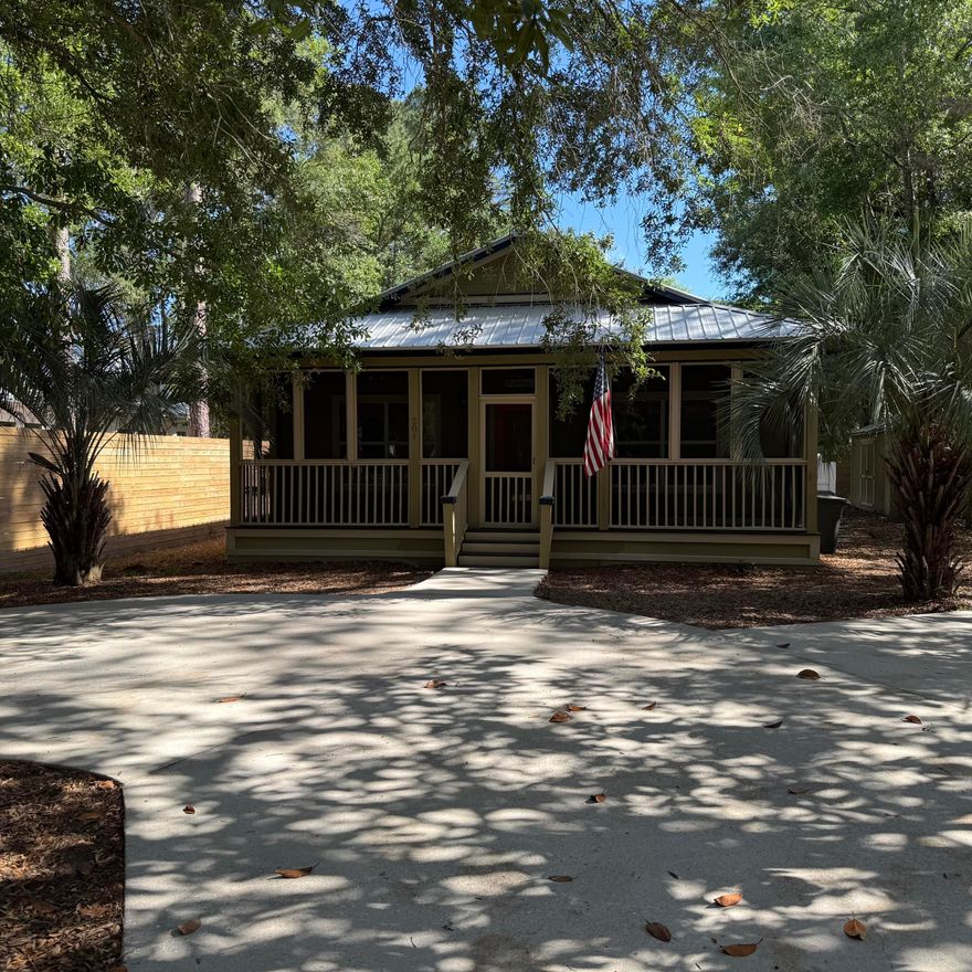 Home is only one block from the Bay and 7-8 minutes to Grayton Beach, SEASIDE, and WATERCOLOR on a very private lot. This is a true Old Florida feel when you enter the street from Bay Dr., and relax on the front porch of this cottage. The surrounding homes are also Old Florida Cottages on large lots. This home has had a screened in porch added off the master bedroom complete with wood burning fireplace and stone mantel nestled under shade trees and native foliage. Owner has added a large outdoor storage shed with electricity. The home is all one level with oak hardwood floors in the
living and dining room. Tile floors are in the kitchen and baths and the countertops are corian. The ceilings are 9 feet everywhere except for the living, dining area which have vaulted ceilings and makes this 1600+ sq.ft. home feel much larger. This home has a very artistic flair and would make a perfect permanent spot for someone wanting peace and quiet with convenience. Buyer to verify all dimensions and measurements. Home being sold "As Is" as the 
Seller lives out of State and will not make any repairs.