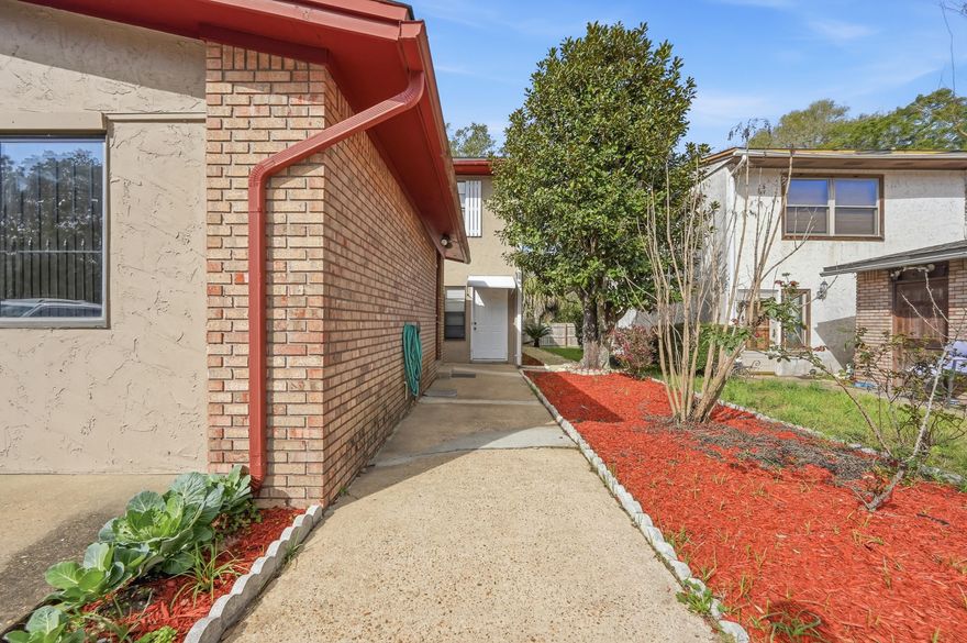 Great investment opportunity! The converted garage studio includes a private bath and kitchenette, perfect for guests, rental income, or multigenerational living. The main home features an updated kitchen with granite countertops, tile backsplash, two pantries, and stainless steel appliances.  Downstairs flooring is tile with vinyl flooring in the upstairs bedrooms. The spacious primary suite includes a private bath, and a Florida room off one guest bedroom adds extra living space. Beautiful landscaping surrounds a large covered patio and a brick-paver patio, ideal for outdoor entertaining. The main home offers 3 bedrooms and 3 bathrooms, while the separate studio adds an additional bedroom and bathroom, bringing the total to 4 bedrooms and 4 bathrooms. Roof 2020, HVAC 2016.