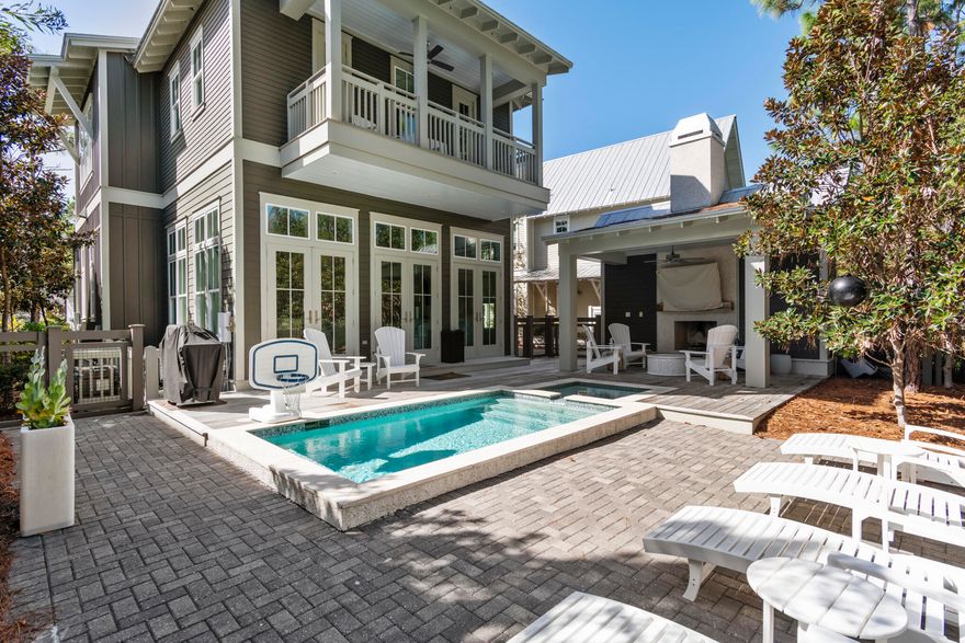 Tucked away in one of WaterColor's most desirable settings, 87 Sunflower Street offers a refined take on coastal luxury with exceptional privacy, backing to peaceful woodlands. Built by Romair in 2015 and thoughtfully updated in 2022, this 4-bedroom residence blends timeless architecture with fresh, high-end finishes and effortless indoor-outdoor living.

The light-filled main level showcases soaring 12-foot ceilings, floor-to-ceiling shiplap, and three sets of French doors that open seamlessly to a beautifully designed outdoor retreat complete with a private pool, hot tub, and fireplace--an ideal setting for entertaining or relaxing after a day at the beach.

The chef's kitchen has been completely reimagined with custom cabinetry, an oversized white quartz island, and premium appliances including Sub-Zero and Wolf, along with a separate cabinet ice maker and beverage cooler. A spacious first-floor primary suite offers a spa-like bath with a freestanding tub and Carrara marble walk-in shower, creating a true retreat.

Upstairs, a generous landing provides flexible space for a sitting area or office, leading to a second primary suite with a private porch overlooking the pool.  The primary suite has a Tub and separate shower. Two additional guest bedrooms, each with ensuite baths, include one with access to a large screened porch featuring a charming porch swing.

Offered fully furnished this home presents an exceptional opportunity as a primary residence, second home, or investment property with strong rental potential.

Ideally located just moments from the WaterColor Beach Club, Camp WaterColor, and the Frog and Dragonfly pools--and a short stroll or bike ride to Seaside's renowned dining and shopping--this home captures the very best of the 30A lifestyle.