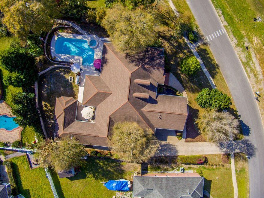 *MOTIVATED SELLER* Spectacular custom home with separate living quarters for extended family or rent potential. The main home showcases an open split floor plan with gorgeous Australian Cypress hardwood floors throughout. Upgraded Kitchen with Breakfast and Florida Room overlooking the salt water in-ground pool. Formal Dinning, Living Room, Family Room, Laundry, 4 bed/2.5 baths and bonus room complete the main home. Private entrance Mother-In-Law Suite with custom kitchen, oversized master and bath with laundry. Additional heated and cooled one room cottage on opposite side of the property with beautiful views of the in ground pool/spa and professionally landscaped yard with stocked koi pond.