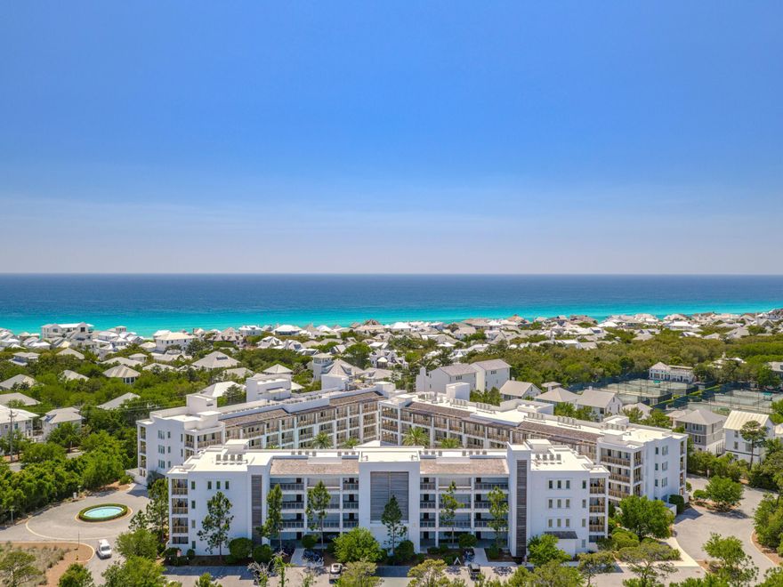 Set within one of 30A's most polished resort settings, this beautifully appointed residence at The Pointe offers a lock-and-leave coastal retreat with the ease of condominium living and the amenities of a boutique vacation destination. Overlooking the award-winning resort-style pool, the interiors are designed for both relaxation and functionality, with an open-concept layout that keeps the kitchen, dining, and living areas connected in an easy, natural flow.

The kitchen is finished with high-end stainless-steel appliances and opens directly to the main gathering space, creating an inviting backdrop for casual mornings and evenings spent entertaining. Just off the kitchen, a stackable washer and dryer add everyday convenience. A private balcony extends the living space outdoors, offering
