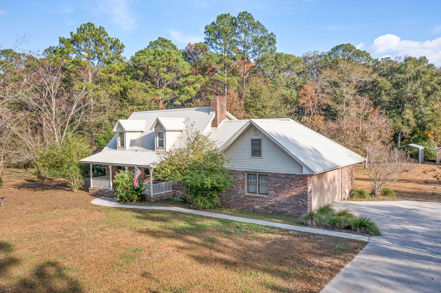 $5,000 buyer agent bonus. Brick home with metal roof on 7± acres with Hwy 277 frontage. Includes oversized RV barn with attached workshop, lean-to storage, fenced area, and carport. Home features covered front and back porches, fresh interior paint, and newer flooring (June 2024 in primary bedroom, living, dining, hall bath, and part of primary bath). Primary bedroom on main level. Kitchen offers ample cabinet space and bay window breakfast area. Upstairs includes additional bedrooms and large walk-in storage. Two HVAC systems replaced 2016-2019. Several window upgrades with additional Andersen windows on order. Ideal for those needing space, storage, or flexibility. The acreage is open and usable, making it ideal for equipment, animals, gardening, or hobby projects. The workshop and RV barn setup provide a functional space for storage, projects, or running equipment without sacrificing room around the home.

The layout offers a practical separation of space with the primary suite on the main level and additional bedrooms upstairs. The walk-in storage room upstairs provides flexibility for seasonal storage, workspace, or potential additional use.

The setting offers a quiet, spread-out feel while still being conveniently located approximately 10 minutes from downtown Chipley, 12 minutes to Falling Waters State Park, about 30 minutes to Northwest Florida Beaches International Airport, and approximately 45 minutes to Panama City Beach.