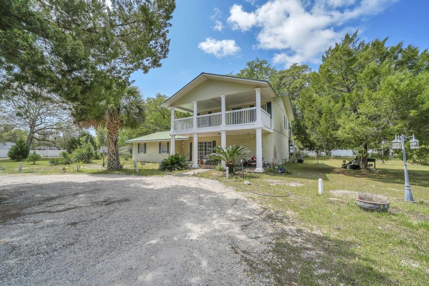Set on 4.63 cleared acres along a paved county road, this unique property features a two-story block construction home with 5 bedrooms and 2 baths, plus an auxiliary mobile home--perfect for extended family, guests, or potential rental income. Currently used as a family compound, the layout offers flexibility for multi-generational living or a live/work setup.

With a privacy fence, quiet surroundings, and expansive usable land, there is ample room to add a workshop, business space, or storage for boats, RVs, jet skis, and more. Located within a mile of Black Creek and just minutes from the beaches and growing Freeport area, this property blends privacy, space, and opportunity in a highly desirable location.