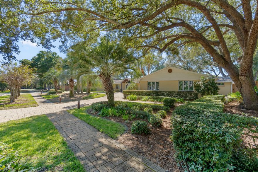 OPEN HOUSE SUNDAY May 3rd, 2026. Step into a home where every detail has been thoughtfully curated to impress & inspire. This fully renovated designer residence welcomes you with a breathtaking foyer featuring a mosaic compass inlay set in marble flooring, soaring vaulted ceilings & a statement chandelier that immediately sets an elegant tone. The expansive main living area is both grand & inviting, showcasing rich bamboo flooring, dramatic vaulted ceilings with cypress beams & a striking marble fireplace framed by custom travertine display niches. Natural light pours in through walls of windows, offering beautiful views of the manicured grounds & circular drive. Designed for both intimate dinners & memorable gatherings, the formal dining room glows beneath two dazzling crystal chandeliers & overlooks your private backyard oasis--complete with lush landscaping, a heated pool & spacious paver entertaining areas. At the heart of the home, the chef's kitchen is as functional as it is stunning, featuring custom cabinetry, granite countertops, Spanish tile flooring & premium appliances including a 5-burner gas cooktop & four-door refrigerator. It opens seamlessly to a dramatic great room with a granite-clad fireplace & a sunlit breakfast area that captures serene pool & garden views. The primary suite is a true retreat, offering travertine flooring, dual ceiling fans, a generous walk-in closet & French doors leading directly to the pool. A private adjoining office with custom mahogany built-ins provides the perfect work-from-home space. The spa-inspired primary bath elevates daily living with marble finishes, dual vanities, a luxurious walk-in shower with multiple massage heads & ample closet space. Two beautifully appointed guest suites each feature their own en-suite baths with marble & designer glass finishes, with one enhanced by a sparkling crystal chandelier for an added touch of elegance. Step outside to your own private sanctuary, where mature tropical landscaping, ambient lighting & a built-in stainless steel grill create the ideal setting for relaxation or entertaining under the stars. Additional highlights include hurricane-rated windows & doors, a spacious laundry room with abundant storage & an oversized two-car garage. Located just steps from the Bay in the sought-after Indian Bayou community--featuring sidewalks, low HOA fees & access to a semi-private Golf & Country club--this exceptional home offers a rare blend of luxury, comfort & effortless Florida living. All information deemed to be correct, but buyers agent to verify all data & information important.