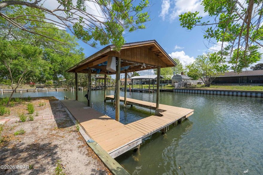 DEEP WATERFRONT LIVING WITH DIRECT GULF ACCESS (10 MINUTE BOAT RIDE TO WEST BAY, 10 MINUTES TO ST. ANDREWS BAY, 17 MINUTES TO SHELL ISLAND) - BRING A BIG BOAT - NEVER WORRY ABOUT WAITING FOR THE RIGHT TIDE.
Your best life awaits at 1311 Capri Drive, Panama City, FL. This expansive 4-bedroom, 2.5-bath home on a corner lot blends coastal convenience with thoughtful upgrades and flexible indoor/outdoor living.
Highlights:
Private dock with a 10,000 lb boat lift on the corner and quick access to open water ideal for fishing, cruising, and sunset outings. Canal depth 20'.
Versatile floor plan: living room, den, and a bright Florida room provide multiple spaces to relax or entertain.
Recently remodeled kitchen with tile backsplash, easy-clean appliances, large pantry, and exposed ceiling beams open to wide living and dining areas with hardwood flooring throughout.
Two stone fireplaces, including a striking double-sided unit between sliding glass doors that opens to the main deck.
Large first-floor laundry room and crawl space under the stairs; open-air patio at the first entry and multiple entrances off the deck for seamless indoor/outdoor flow.
Spacious back porch with a fish-cleaning station perfect for anglers and outdoor gatherings.
Second-floor layout features a second master suite with oversized his-and-hers walk-in closets and an additional closet, plus a large private deck with distant West Bay water views. Two guest bedrooms and a shared bath sit conveniently between them.
New exterior paint and well-maintained finishes throughout.
Short-term rental allowed.
Located in an established waterfront neighborhood close to beaches, marinas, shopping, and dining, this property offers true coastal living with easy access to everything the Gulf Coast has to offer. Schedule your showing to experience the lifestyle and waterway access firsthand.