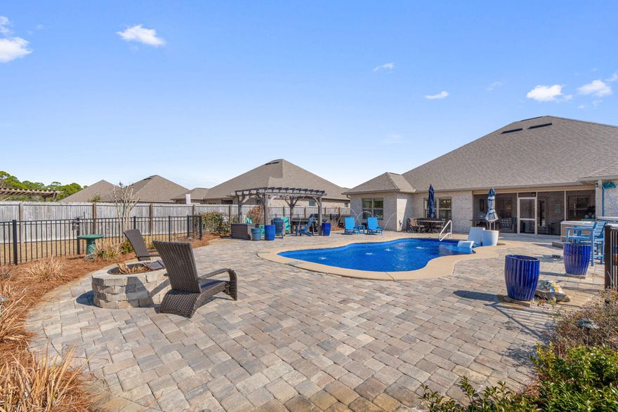 NATURE'S COVE LUXURY WITH BACKYARD OASIS! Experience the ultimate Florida lifestyle in this stunning 4BR/3BA all-brick Craftsman retreat off prestigious Soundside Drive. Moments from sugar-white beaches, this home features a spacious open floor plan with high ceilings, double tray ceilings, crown molding, and wood-look tile centered by a cozy gas fireplace. The Chef's Kitchen is a showstopper with Quartz countertops, upgraded staggered cabinetry, a custom backsplash, and premium stainless appliances.
The Private Primary Suite is a true sanctuary, boasting tray ceilings and a spa-like ensuite with Quartz double vanities, a frameless tile shower, a soaking tub with elegant tile surround, and a massive custom walk-in closet. Home has a 2nd primary with its own full ensuite & privacy from the other bedrooms.
2 additional guest suites with a full bathroom.
YOUR PRIVATE RESORT AWAITS: The backyard is an entertainer's dream, featuring an in-ground pool with tanning ledge, hot tub, expansive paver patio, grilling station, and a separate fire pit. For ultimate safety and aesthetics, the yard features a dual-fence system: a black wrought iron fence enclosing the pool and a wood privacy fence encompassing the entire backyard.
JUST A FEW OF THE FEATURES & LOCATION:
3-Car Garage for vehicles and beach gear.
Recent Systems: New irrigation with rust preventer tank and gutters.
Prime Setting: Perfectly nestled between Pensacola and Navarre Beaches; minutes to boat ramps, scenic trails, and Downtown Pensacola.
Don't miss this rare opportunity in Nature's Cove schedule your showing today!