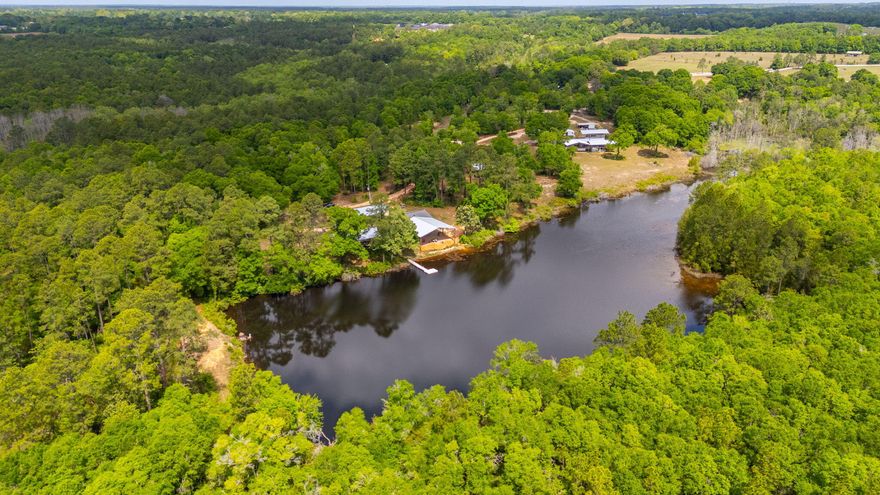 This expansive property located in Baker, Florida offers a significant land opportunity with over 62 acres of mature hardwoods and pines. The centerpiece is a rare spring-fed, sandy bottom lake, providing a private and serene atmosphere.  Property has a large older brick home and double wide with several new pole barns for shelter and storage located throughout the property.  Baker/Holt provides easy access to Crestview, I10, Eglin AFB or the beach.  Make this your dream home, family compound, or a excellent income producing opportunity, call today for a private tour.