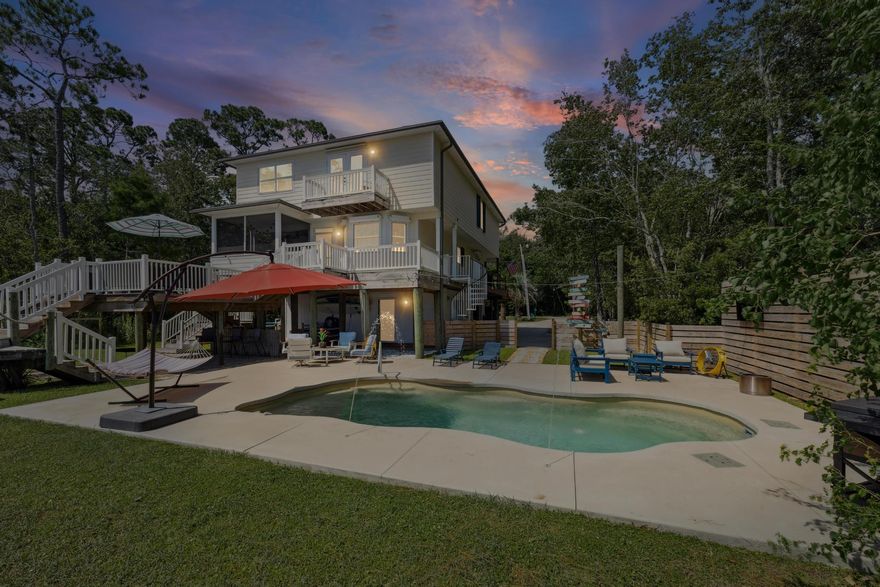 Welcome to this beautifully updated 5-bedroom, 3.5-bathroom waterfront home in Navarre, offering nearly 2,700 square feet of living space on a spacious 0.50-acre lot. This home features two primary suites, offering ultimate flexibility and comfort. A third full bathroom has been added, enhancing convenience for guests or family members. With thoughtful design elements throughout, one of the bedrooms can be easily closed off with a pocket door--creating an expansive suite with two additional closets and a unique layout to suit your lifestyle needs. Tucked away on a quiet dead-end street, this property provides both privacy and stunning water views. Enjoy direct access to the water with your own boat lift (upgraded in 2025), boathouse with utilities, and a private pier. Outdoor living is elevated with a screened-in porch (remodeled in 2024), a gorgeous in-ground pool added in 2023, and a fully re-landscaped backyard. Inside, the home has seen extensive renovations, including new flooring throughout (2021), a freshly painted interior (2025), and a remodeled laundry room/pantry (2024). The kitchen features freshly painted cabinets (2021) and newer appliances including a microwave, stove, and dishwasher (2023), plus a new refrigerator (2025). Functional upgrades include a new downstairs AC unit (2025), new roof (2021), new Leaf Guard gutters (2024), and a dumbwaiter from the first to second floor. Interior spaces have been thoughtfully reconfigured, with a loft converted into a 4th bedroom (2021) and a front living room transformed into a 5th bedroom (2024). The home also boasts a remodeled half bath (2025), an added third full bath (2025), and stylish lighting and ceiling fan updates (2023). Additional highlights include a rebuilt front staircase with modern cable handrails (2023), new washer and dryer (2024), new window screens (2022), a fenced-in yard (2024), and added parking (2021). This exceptional home combines modern comforts with waterfront living.