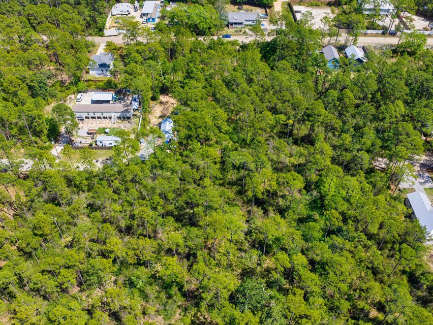 A spacious homesite with mature landscaping that would be ideal for a primary residence, vacation home, or an income-generating property. The property is not subject to homeowners association regulations and does not require a build-out period. It is conveniently located near the Cessna Landing boat launch and the restaurants, shops, and beaches of South Walton.