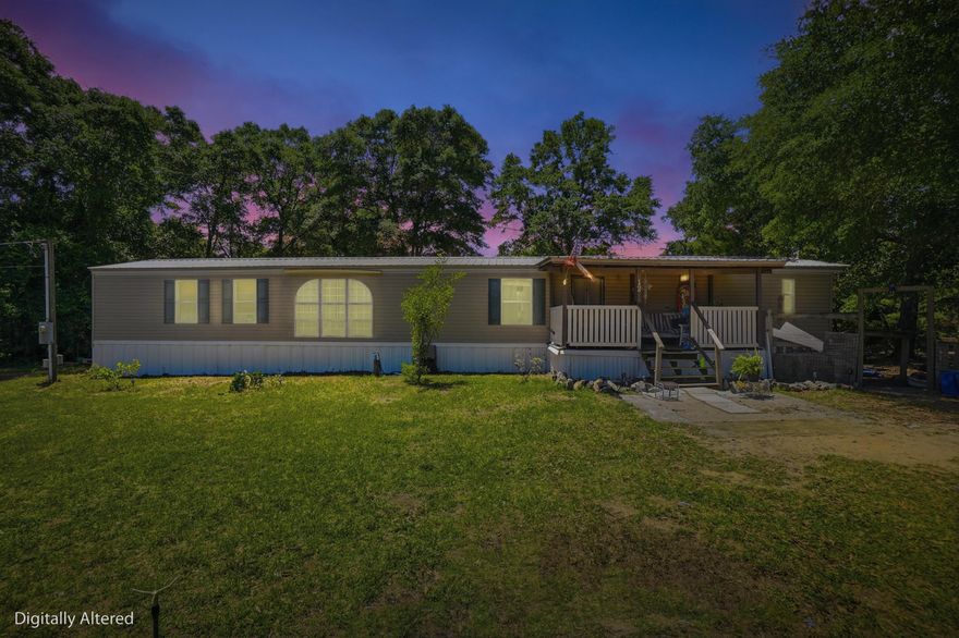 Nice mobile home situated on two lots totaling approximately 0.57 acres, conveniently located near Highway 90 with no HOA. This property offers plenty of space with a large fenced-in backyard, perfect for pets, outdoor activities, or additional storage.

The home features 3 bedrooms and 2 bathrooms, with the current layout converted into a 2-bedroom configuration for a larger living space, but it can easily be converted back to a full 3-bedroom if desired. The master suite includes a walk-in closet, garden tub, and a separate walk-in shower.

Enjoy outdoor living with a large covered front porch, along with additional deck space. The property also includes a yard building for extra storage.

The kitchen comes equipped with a refrigerator and stove, and the home offers vinyl flooring, central HVAC, and washer/dryer hookups.

While the home could use a little TLC, it is move-in ready and presents a great opportunity for a primary residence, rental, or investment property.

Situated on a corner, level lot with easy access via a maintained county road, this property offers both convenience and flexibility.