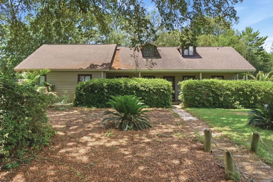 Experience the perfect marriage of ''old Florida'' majesty and modern peace of mind. Perched on high and dry corner lot in Holley by the Sea, this oversized property has over .6 acres and offers a yard like a private forest.  The property is a nature lovers dream with a 450-year-old oak tree; stunning canopy of 200-250-year-old oaks and plenty of room for a swimming pool all in Flood Zone X so no flood insurance required.  Inside, this 2 bedroom, 2 bathroom home feels large due to the soaring vaulted ceilings and new neutral paint.  15ft ceilings are lined with gorgeous cedar wood.  It has a split bedroom plan with 15 ft vaulted ceiling in the master and 13 ft vaulted ceiling in the spare bedroom.  The living room offers adjacent 112 square foot sun room.  The home has a large kitchen with breakfast bar AND breakfast nook and lots of cabinets and countertop space.  Only 10 minutes from the beach, Holley By The Sea offers the most amenities in Navarre with swimming pools, tennis courts, gym, basketball courts, community room, RV park and more!  New roof is coming soon!