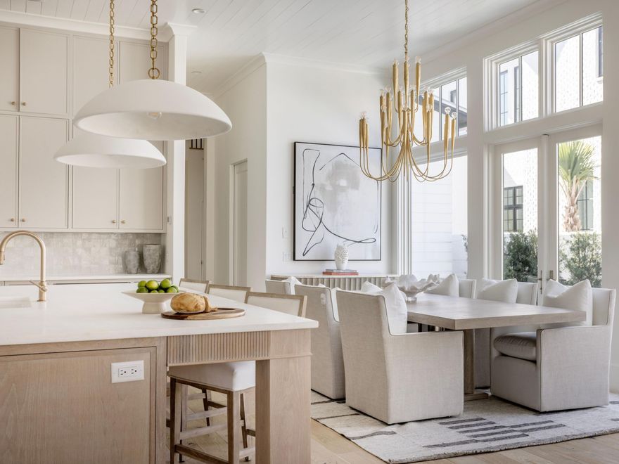 Privately positioned within the gates of Churchill Oaks, this striking lake front residence offers a refined blend of architectural integrity, thoughtful design, and elevated coastal living. Designed by Savoie Architects and constructed by Grand Bay Construction, the home spans three expansive levels and features five bedrooms, five and one-half baths, a private carriage house, and a fully integrated elevator providing effortless access between floors. Natural textures and timeless finishes define the interior, including wire-brushed white oak flooring, Old Chicago brick accents, and custom lighting throughout. The main living space is anchored by a chef's kitchen with Sub-Zero and Wolf appliances, marble countertops, and classic shaker cabinetry, opening seamlessly into the dining and living areas. A built-in wet bar and large glass doors extend the living space outdoors to a private courtyard with a pool and summer kitchen, ideal for relaxed entertaining.
The primary suite has been thoughtfully enhanced with a newly added expansive custom closet, offering exceptional storage and functionality while elevating the overall livability of the space. The elevator services the home, adding everyday convenience and long-term accessibility across all levels.
Additional features include a third-level bonus room with full bath, a climate-controlled carriage suite with its own HVAC system, dual laundry rooms, tankless water heaters, Cat6 wiring, recessed speaker systems, and multiple covered verandas designed for year-round enjoyment. The home is partially furnished, providing a curated foundation while allowing flexibility for personalization.
Set along the tranquil waters of Hogtown Bayou, Churchill Oaks is a premier waterfront community offering a bayou front clubhouse, resort-style pools, fitness amenities, scenic walking paths, and a deep-water marina, all within minutes of 30A's dining, shopping, and beaches.