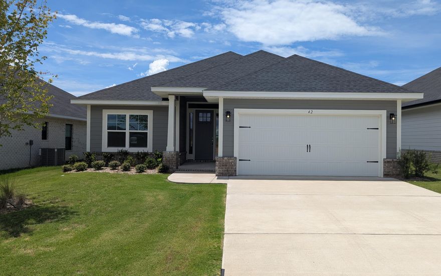 Just 20 minutes from the sugar-white sands of South Walton and 30A, this sought-after Craftsman-style 4-bedroom, 2-bath residence blends timeless design with refined finishes. Upgraded LVP flooring flows throughout the home, while the main living area is enhanced by a dramatic cathedral ceiling and 9'+ ceiling heights throughout. Eight-foot entry doors and quartz countertops add to the home's upscale appeal. The spacious owner's suite offers a generous walk-in closet, creating a true private retreat. Outdoors, enjoy a fully sodded yard with an automated sprinkler system, and the convenience of a garage door opener completes this exceptional home. *Furnished pics are like plan but selections or features may be different than actual home for sale.*