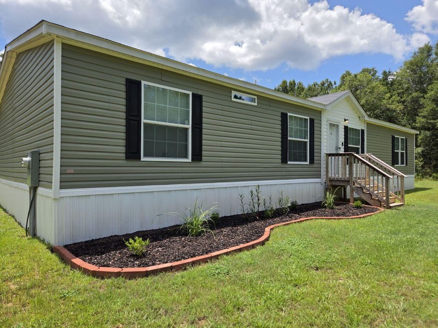 Built in 2022, this beautifully maintained 4-bedroom, 2-bath manufactured home sits on 2 private acres of peaceful, rural land—perfect for those craving space, privacy, and the freedom to live life on their own terms. Step inside to find modern fixtures, a spacious open layout, and a home that feels like new. The property is equipped with a well and septic system, making it ideal for anyone dreaming of a more self-sufficient lifestyle. Whether you're looking to homestead, raise a family away from the noise, or simply enjoy the quiet of country living, this home offers a rare opportunity to do it all—without sacrificing comfort or convenience. Schedule your private showing today and come experience the serenity for yourself!