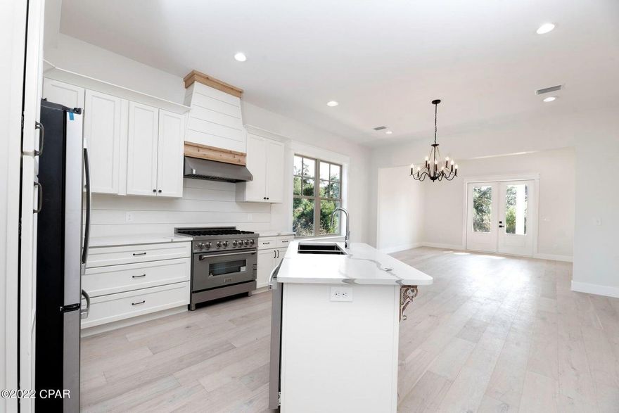 LOWEST PRICED PER SQUARE FOOT, CUSTOM (NON-D.R. HORTON HOME) IN SANCTUARY BEACH!

Beautifully crafted and impeccably maintained, this 4-bedroom Craftsman home in the highly sought-after Sanctuary Beach subdivision offers the perfect blend of timeless design, modern upgrades, and coastal convenience. Move-in ready and thoughtfully enhanced throughout, this residence delivers both comfort and sophistication in a serene, wooded setting. Ideally positioned within the community, the home is just moments from the neighborhood pool and approximately ¼ mile to the nearest beach access, making it easy to enjoy the best of the Emerald Coast lifestyle.

Inside, the open-concept floor plan is filled with natural light and elevated by white oak flooring, soaring ceilings, and expansive windows. The chef's kitchen is a true centerpiece, featuring white cabinetry, marble countertops, a shiplap and cedar backsplash, breakfast bar, upgraded stainless steel appliances, and a ZLINE commercial-grade range with six gas burners, electric oven, and vent hood. A spacious butler's pantry adds both function and style.

The main living and dining areas are designed for effortless entertaining, highlighted by a vaulted ceiling and 8-foot folding French doors that open to an oversized patio and backyard perfect for seamless indoor-outdoor living.

The main-level primary suite offers a private retreat, complete with reclaimed 9-foot barn doors, a spa-inspired bathroom with marble flooring, a large glass-enclosed shower, double vanities, a freestanding soaking tub, and an expansive custom walk-in closet.

Upstairs, you'll find three generously sized bedrooms, a full bath with tiled tub/shower and double vanity, and a spacious laundry room with additional storage and natural light. A convenient powder room is located on the main floor for guests.

Additional features include full insulation of all interior and exterior walls, blown-in ceiling insulation for enhanced energy efficiency, a paver driveway, and an attached two-car garage.

Located near a Jack Nicklaus-designed golf course, multiple marinas, St. Andrews State Park, and an array of dining and entertainment options, this home offers both tranquility and accessibility.

This exceptional property captures the essence of Sanctuary Beach living, schedule your private showing today.