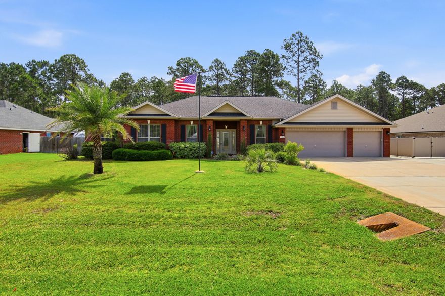 Located in the highly sought-after community of Holley by the Sea in Navarre, this beautifully maintained residence offers an exceptional blend of comfort, privacy, and refined coastal living. Set on an expansive .58-acre homesite surrounded by mature trees, the property provides a rare sense of space and seclusion while still being part of one of the area's most desirable neighborhoods. Inside, you're welcomed by a thoughtfully designed split floor plan featuring four spacious bedrooms, two full bathrooms, and a dedicated private office--ideal for remote work or a quiet study without sacrificing a bedroom. The interior is enhanced with durable COREtec wood-look plank flooring throughout the main living areas and bedrooms, creating a cohesive and modern feel with no carpet in sight.

At the center of the home, the kitchen is designed for both everyday living and entertaining, offering granite countertops, stainless steel appliances, a high-top breakfast bar, a generous pantry, and a bright breakfast nook that fills the space with natural light.

The primary suite is a true retreat, accessed through elegant French doors and offering an oversized layout with plenty of room to unwind. The en-suite bath impresses with its scale and features, including an expansive walk-in shower and abundant space throughout. On the opposite side of the home, the additional bedrooms provide privacy and convenience, with the second bathroom offering direct access to the backyard--perfect for outdoor living and entertaining.

One of the standout features of this property is the immaculate three-car garage, complete with a glossy epoxy floor finish and built-in storage cabinetry, making it as functional as it is impressive.

The exterior living spaces are equally inviting, featuring a fully fenced backyard, covered patio, and a wood deck that overlooks the natural wooded backdrop. Additional highlights include a sprinkler system on a private well, underground utilities, Levelor blinds throughout, fabric hurricane window protection, and sewer service (no septic).

This is a rare opportunity to own a spacious, well-appointed home in Holley by the Sea that offers both privacy and convenience, all within a highly desirable coastal community with incredible amenities and lifestyle appeal