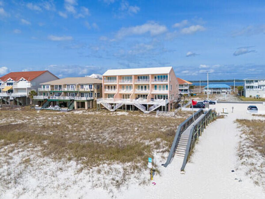 BRING AN OFFER! MOTIVATED SELLER! CASH FLOWING OPPORTUNITY ON THE BEACH! Fully furnished! 
BRING AN OFFER! COME SEE IN PERSON! This turnkey, income-producing waterfront townhome sits directly on the emerald waters of the highly desirable Navarre Beach and offers projected annual rental income of $150,000!!! NO HOA FEES! WOW!!
Sold fully furnished and rental-ready, the three-story layout comfortably sleeps up to 10 guests, making it ideal for short-term vacation rentals or a second home with strong income potential. The first floor features an open-concept living, dining, and kitchen area with tile flooring throughout and sweeping Gulf views. MOTIVATED SELLER! BRING AN OFFER! The updated kitchen includes freshly painted gray cabinetry, granite countertops, stainless steel appliances, and an ice machine, while the spacious partially covered balcony provides ample outdoor seating--an attractive feature for renters seeking a true beachfront experience.

The second floor offers three well-appointed bedrooms, two of which have private covered balconies overlooking the Gulf, along with a conveniently located full bath and laundry closet. The third level enhances revenue appeal with a private primary suite featuring its own covered balcony with Gulf views, a jetted tub, separate walk-in shower, double vanities, walk-in closet, and private water closet. An additional large bedroom on this level includes views of the Intracoastal Waterway and a private full bath, offering flexibility for multi-family or group bookings. Located just minutes from Navarre Beach Marine Park, Navarre Beach Boat Launch, and the Navarre Beach Fishing Pier--the longest fishing pier in the Gulf--and a short scenic drive through Gulf Islands National Seashore to Pensacola Beach, this property benefits from strong year-round rental demand driven by beachfront access, boating, fishing, and water recreation. With limited Gulf-front inventory and no HOA restrictions, this property presents a compelling opportunity for investors seeking immediate cash flow and long-term coastal appreciation. ASK FOR THE CASH FLOW SHEET! Come see it today!!