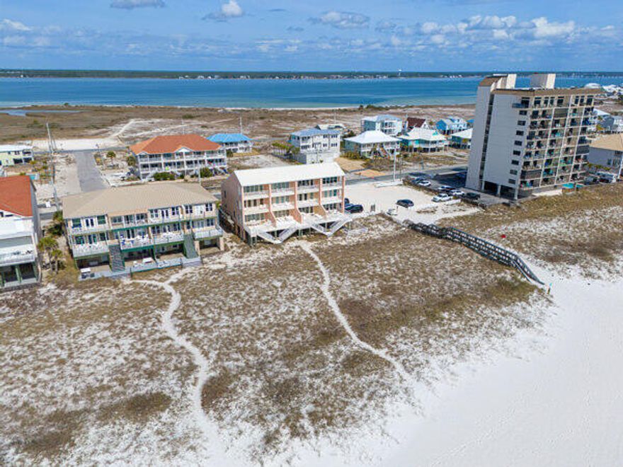 CASH FLOWING OPPORTUNITY ON THE BEACH! Fully furnished! 
BRING AN OFFER! COME SEE IN PERSON! This turnkey, income-producing waterfront townhome sits directly on the emerald waters of the highly desirable Navarre Beach and offers projected annual rental income of $150,000!!! NO HOA FEES! WOW!!
Sold fully furnished and rental-ready, the three-story layout comfortably sleeps up to 10 guests, making it ideal for short-term vacation rentals or a second home with strong income potential. The first floor features an open-concept living, dining, and kitchen area with tile flooring throughout and sweeping Gulf views. MOTIVATED SELLER! BRING AN OFFER! The updated kitchen includes freshly painted gray cabinetry, granite countertops, stainless steel appliances, and an ice machine, while the spacious partially covered balcony provides ample outdoor seating--an attractive feature for renters seeking a true beachfront experience.

The second floor offers three well-appointed bedrooms, two of which have private covered balconies overlooking the Gulf, along with a conveniently located full bath and laundry closet. The third level enhances revenue appeal with a private primary suite featuring its own covered balcony with Gulf views, a jetted tub, separate walk-in shower, double vanities, walk-in closet, and private water closet. An additional large bedroom on this level includes views of the Intracoastal Waterway and a private full bath, offering flexibility for multi-family or group bookings. Located just minutes from Navarre Beach Marine Park, Navarre Beach Boat Launch, and the Navarre Beach Fishing Pier--the longest fishing pier in the Gulf--and a short scenic drive through Gulf Islands National Seashore to Pensacola Beach, this property benefits from strong year-round rental demand driven by beachfront access, boating, fishing, and water recreation. With limited Gulf-front inventory and no HOA restrictions, this property presents a compelling opportunity for investors seeking immediate cash flow and long-term coastal appreciation. ASK FOR THE CASH FLOW SHEET! Come see it today!!