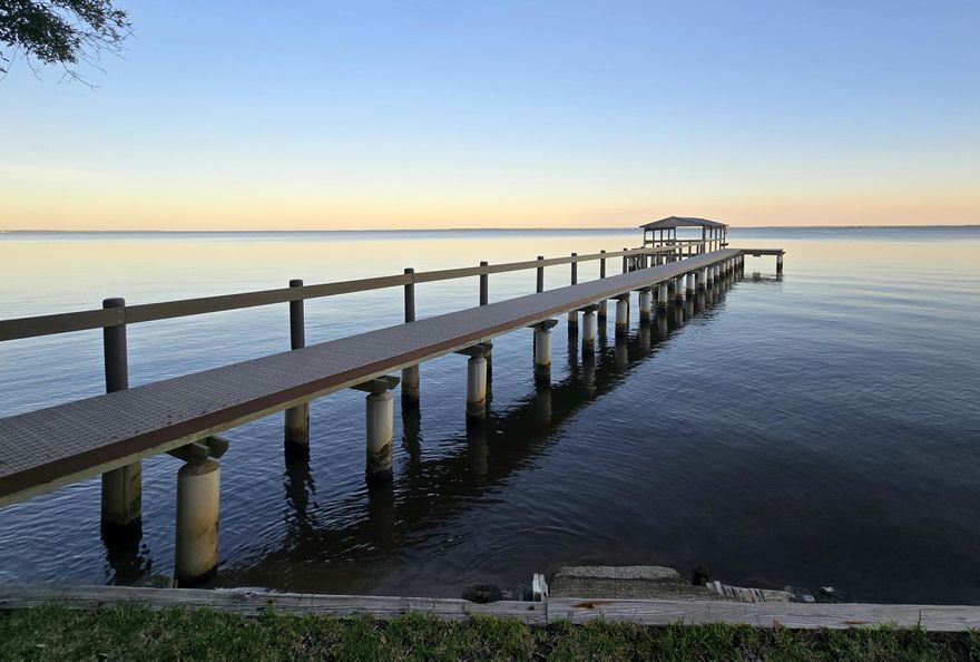 Waterfront living at its finest w/stunning bay views, beautifully rebuilt dock w/composite decking & concrete pilings, & raised seawall for added elevation, plus private Mother in Law Suite! This 3BR/3BA, 3,276 SF home on 0.80 acres features a full MIL Suite w/its own entrance, kitchenette, full bath, & walk in closet, ideal for guests or multigenerational living. Inside, enjoy cathedral ceilings, skylights, spacious living areas, & a bright sunroom overlooking the water. The kitchen includes a Jenn Air smooth top stove, island w/breakfast bar, & stainless/black appliances. Additional features: metal roof, hurricane shutters, & 2 car garage. Conveniently located minutes to Niceville, Destin, Hwy 331, top rated schools, medical facilities, shopping, & dining. A private showing awaits you.
