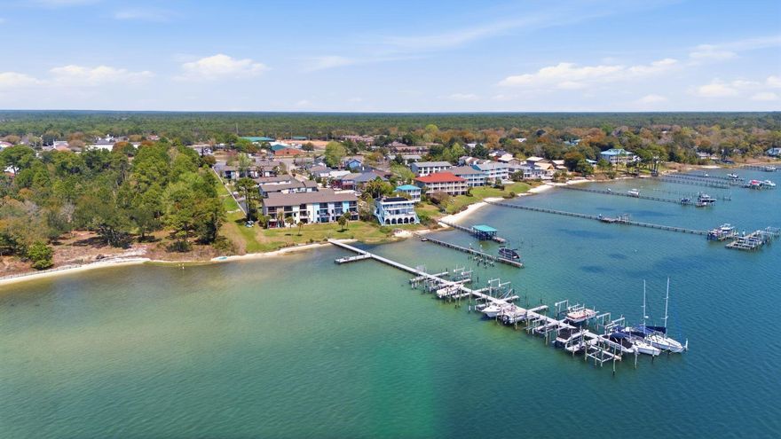 Gorgeous townhome in a waterfront community, and this corner unit comes WITH A BOAT SLIP! The downstairs has stunning wood look tile, and the kitchen includes granite countertops and all appliances convey, including full size washer and dryer! There are 2 bedrooms and 2 full baths upstairs, and the master bedroom balcony overlooks the beautifully landscaped courtyard and pool. Conveniently, there is also a half bath downstairs, next to the spacious storage closet. Whether you are looking for a great investment property or personal, relaxing oasis, don't miss this wonderful opportunity to own a piece of paradise!