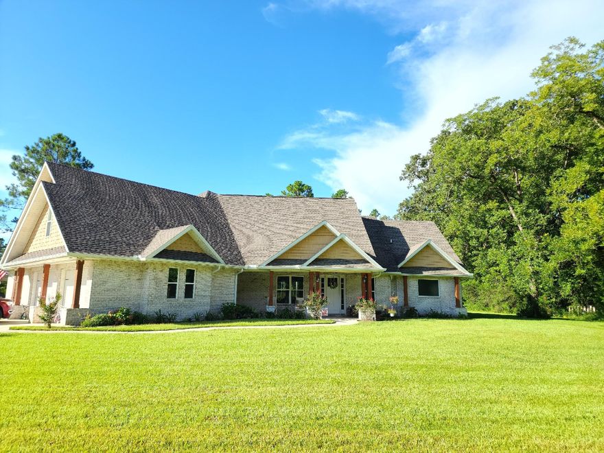 Beautiful 4 bedroom, 3.5 bath home located in a serene country setting just North of Crestview. You will be welcomed by a lovely large front porch. Enjoy a spacious floor plan with two sitting rooms that feature electric fireplaces and two eating areas that make entertaining ideal for Holidays or Special occasions. The kitchen has white cabinetry and a large granite island for seating. Lots of windows and ten ft walls give this home an open feel while enjoying the outdoor scenery and wildlife. In the main areas there is a lovely wood look tile flooring with carpet in the bedrooms. The master suite is very spacious and features a luxury master bath with a relaxing jetted tub. The back porch overlooks a large backyard. with a spacious 40x72 barn with a 30x30 breezeway. Also a 24x60 Pole barn