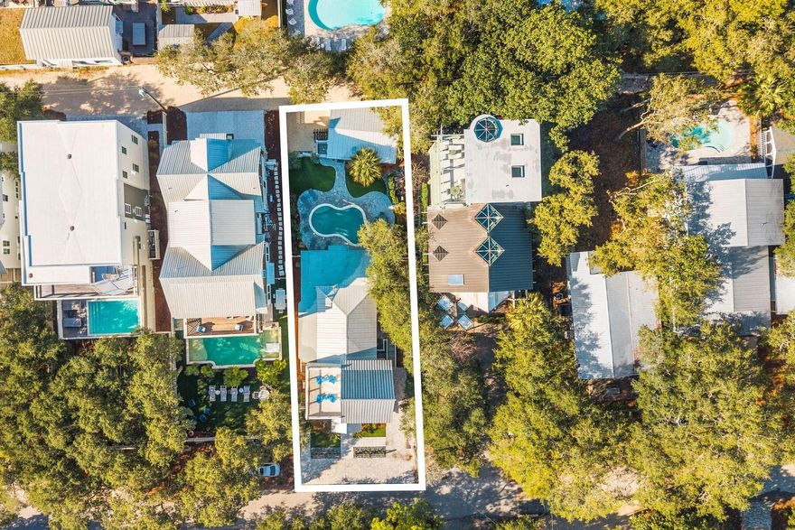 Timeless Grayton Beach character meets thoughtful modern renovation in this rare fully-furnished, dual-residence offering just steps from Western Lake, the shoreline, and the heart of one of 30A's most storied beach villages. Originally built in 1970 and extensively reimagined, the property pairs a gracious main home with a fully detached private cottage, creating flexibility for hosting, multigenerational living, or income potential without sacrificing privacy or charm.
The main residence spans approximately 2,910 square feet with five bedrooms and four-and-a-half baths across three levels. Recent updates include a fully redesigned kitchen, renovated bathrooms, fresh interior paint, new flooring, updated wiring and plumbing, two HVAC systems, new appliances, and a new roof. From the inviting front porch, morning coffee is enjoyed with tranquil views toward Western Lake. Inside, the first floor opens to a generous living and dining area that flows seamlessly into the kitchen, which offers ample space for an island and connects to a comfortable sitting or game room. A mudroom off the kitchen adds a half bath, a full-sized laundry, and direct access to the side yard for grilling.
Two first-floor bedrooms feature updated ensuite baths, while a rear hallway leads directly to the backyard. Upstairs, the second level offers two additional bedrooms and two full baths. The third floor serves as a flexible retreat or bedroom, highlighted by a striking wood A-frame ceiling with access to the large balcony.
The detached cottage provides approximately 560 square feet with one bedroom, one full bath, a family room, a full kitchen, a laundry room, an outdoor shower, and a separate entrance. With a new roof and alley access, the cottage allows easy movement to the beach, lake, and dining while remaining discreetly set apart from the main home.
Outdoor living is equally compelling, with a spacious backyard ready for relaxed afternoons, a newly added private pool, curated hardscape, and lush landscaping. After a day on the water, rinse off at the outdoor shower or unwind in one of several private seating areas. Parking is generous with a paver driveway, additional front parking, and two rear spaces for a total of seven. Accessibility has been carefully considered with a ramp on the north side and a fully accessible first floor, including the primary bath.
Both residences may be rented separately or together, offering exceptional versatility. Positioned moments from Western Lake, two beach accesses, and iconic spots like The Red Bar, Chiringo, and AJ's Grayton Beach, this is a rare opportunity to own a true Grayton Beach classic where coastal history, modern updates, and an unbeatable walkable setting come together with ease.